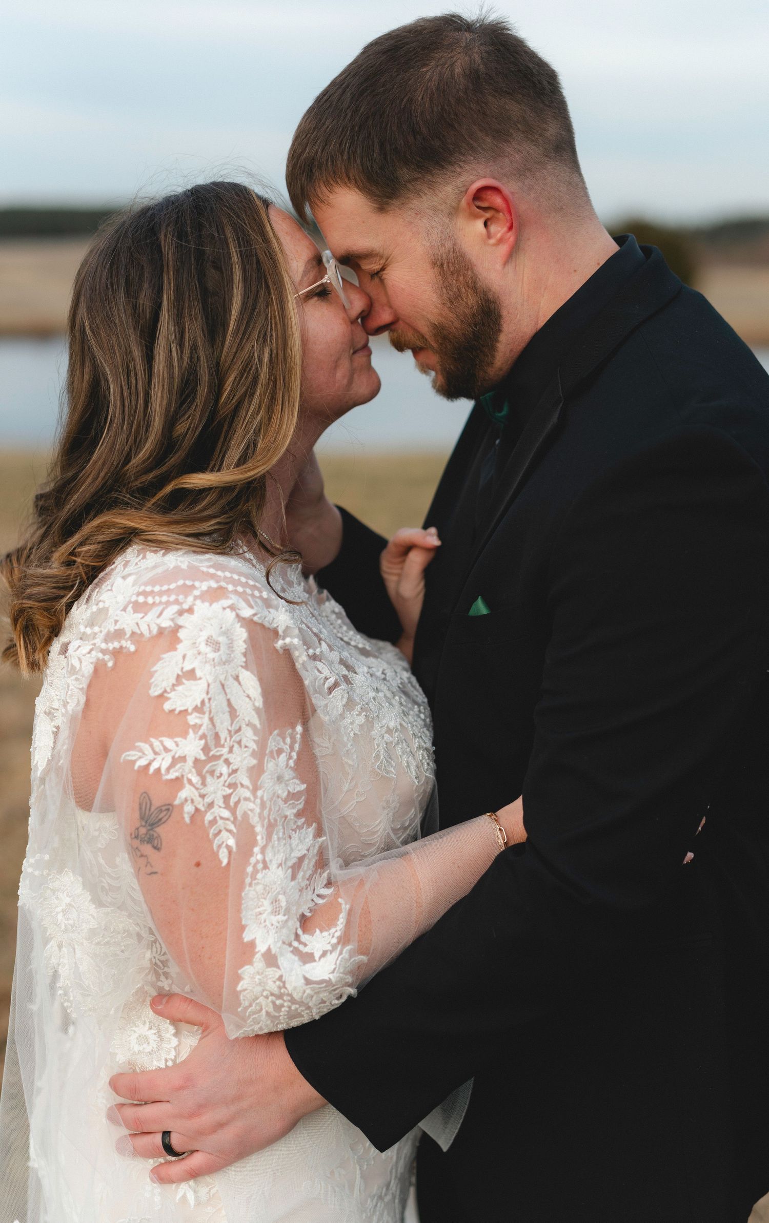 Romantic wedding couple embraces in a series of intimate moments against a scenic outdoor backdrop.