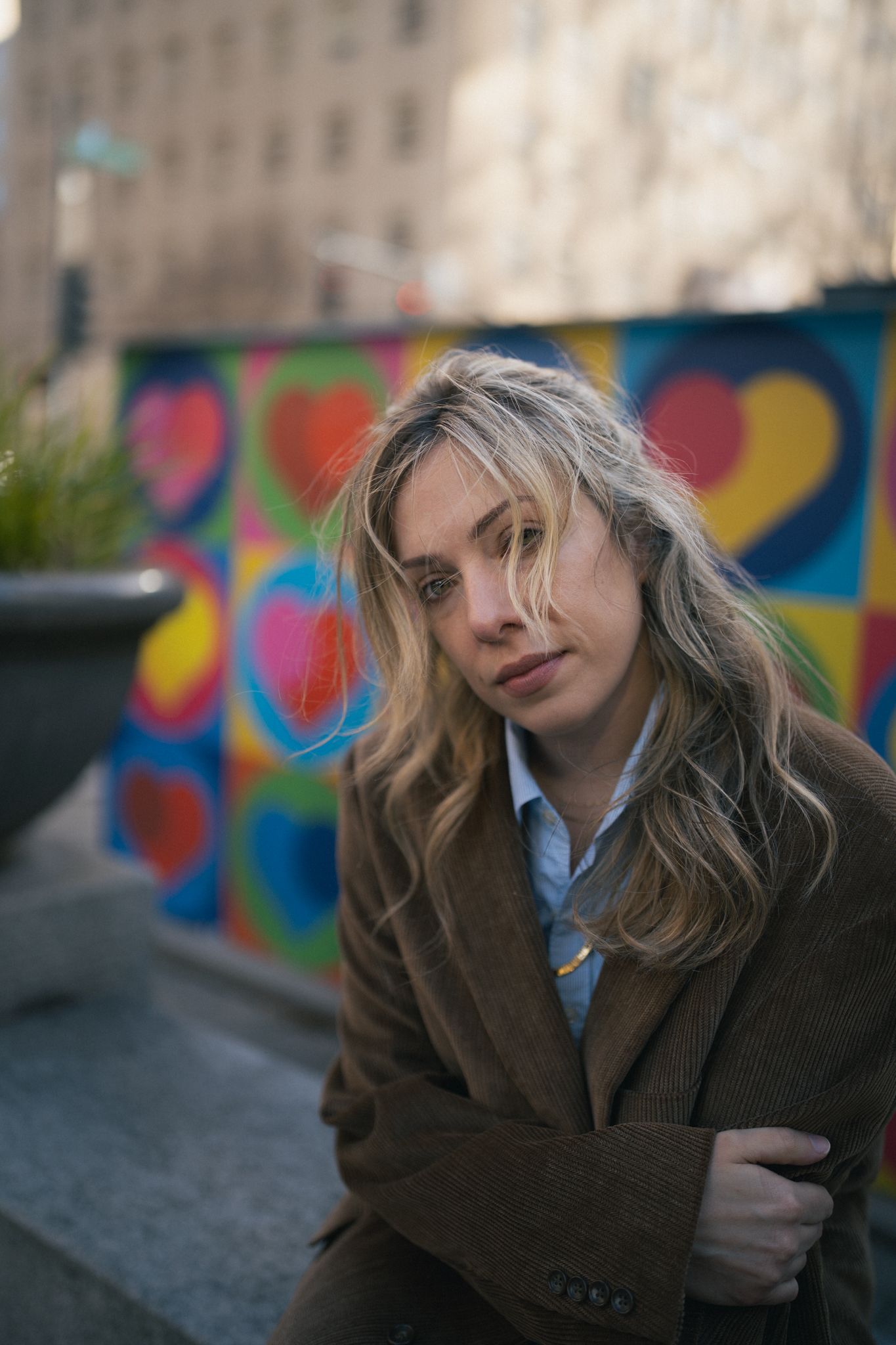 Artistic portrait series against colorful street art mural background.