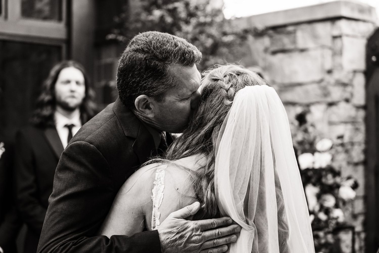 Black and white emotional moment during outdoor wedding ceremony.