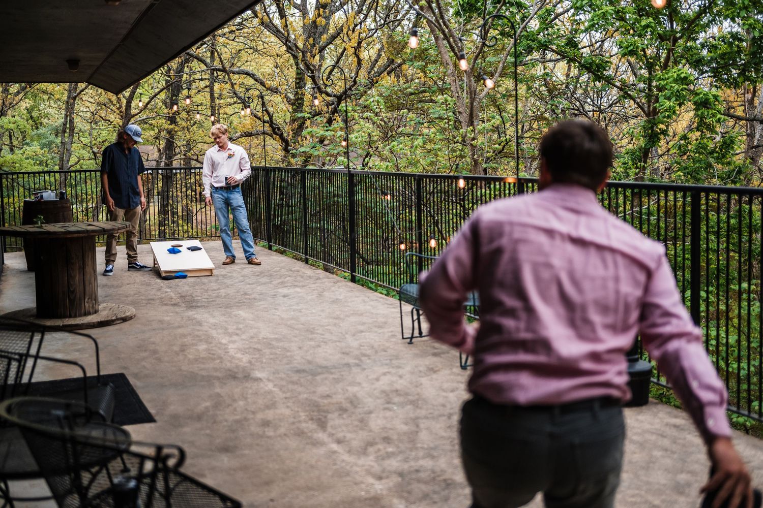 A behind-the-scenes view of photographers capturing a couple during an outdoor photoshoot.
