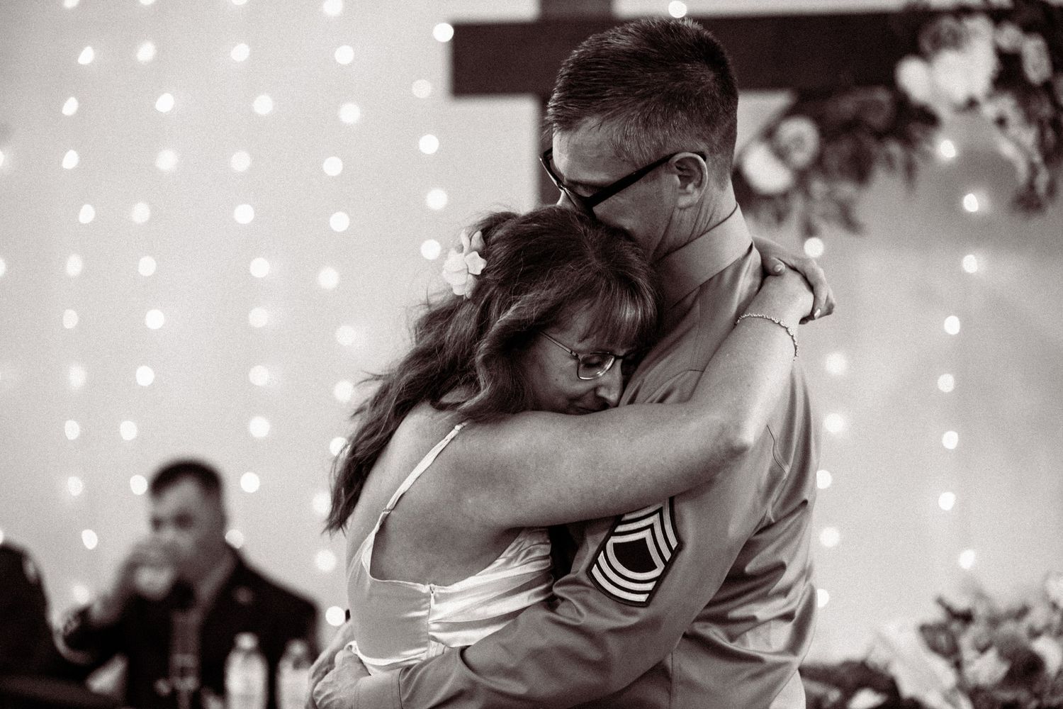 An intimate wedding dance moment with string lights creating a magical atmosphere.