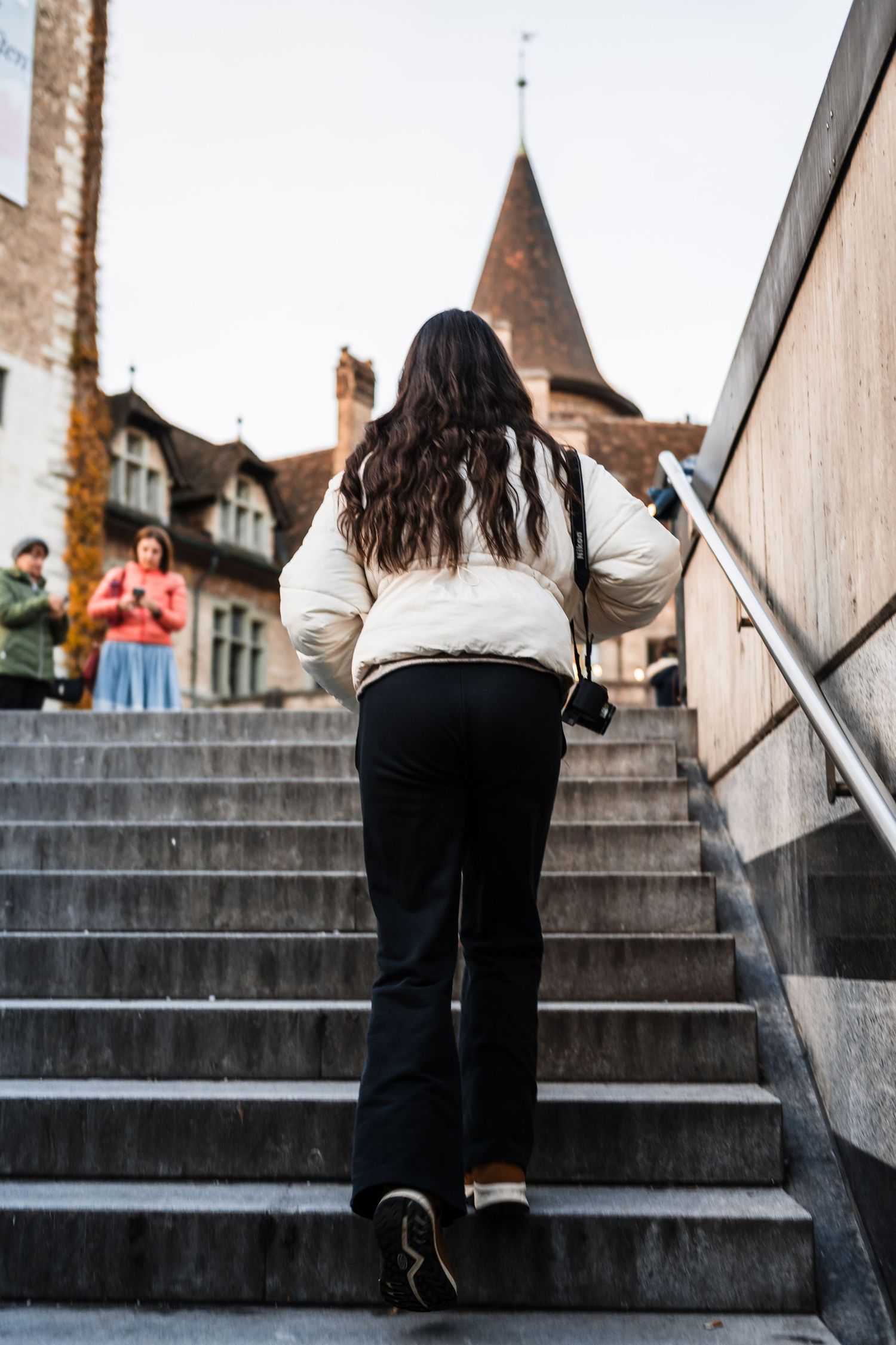Person in white shirt and dark pants climbing concrete steps in a progressive sequence of photos.