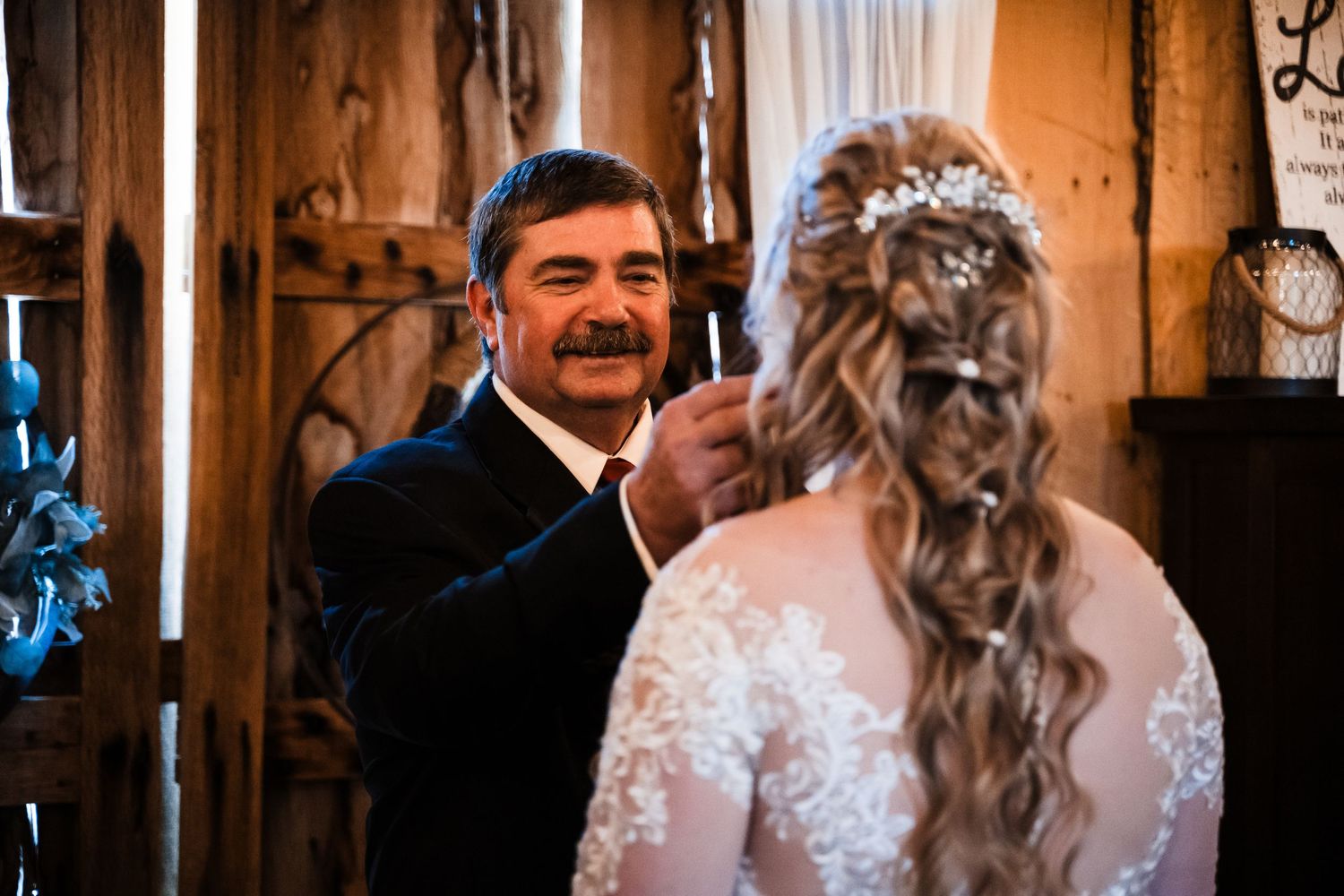 A tender moment shared between two people during an indoor wedding ceremony.