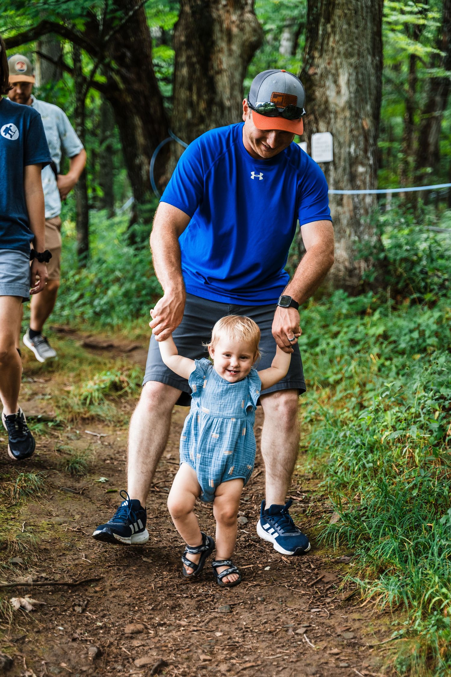 A heartwarming walk together on a shaded forest path.