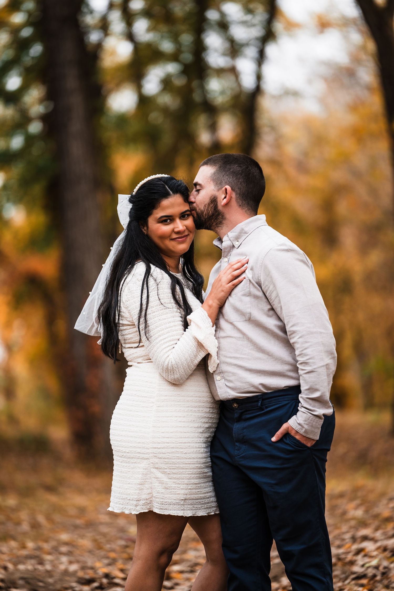 Intimate moment between couple during autumn photo session.