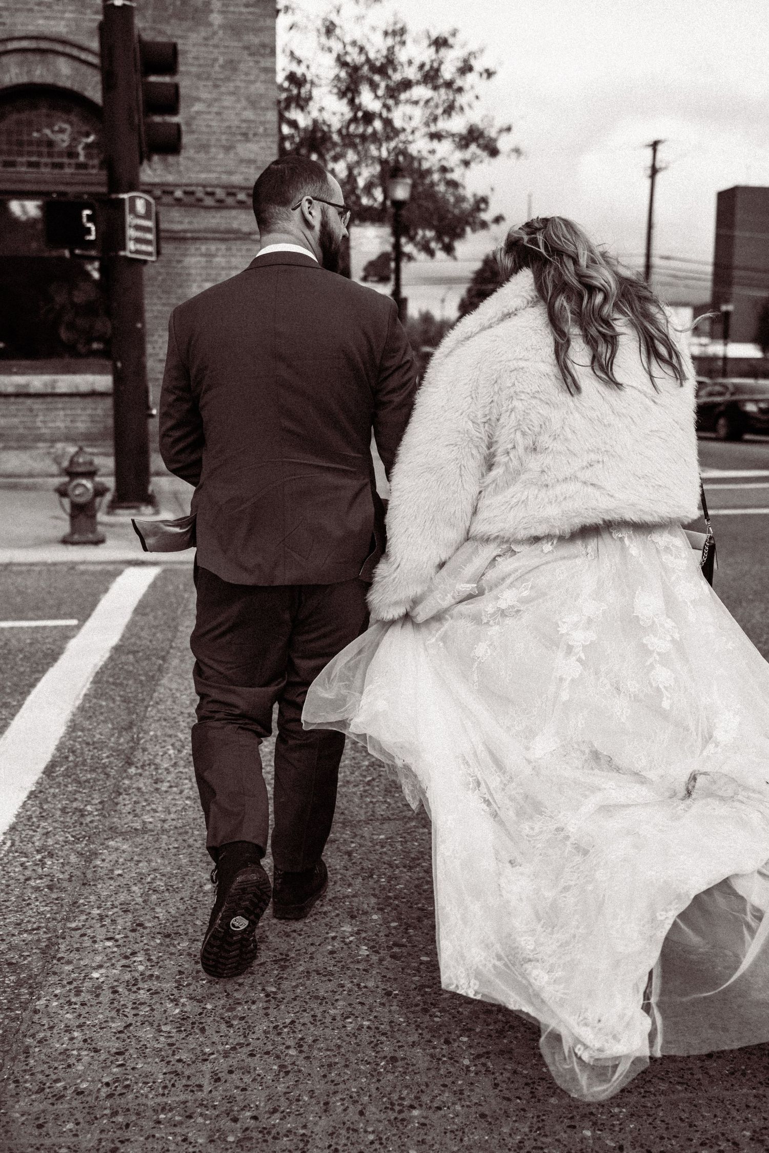 Black and white sequence of a couple walking together on an urban sidewalk.