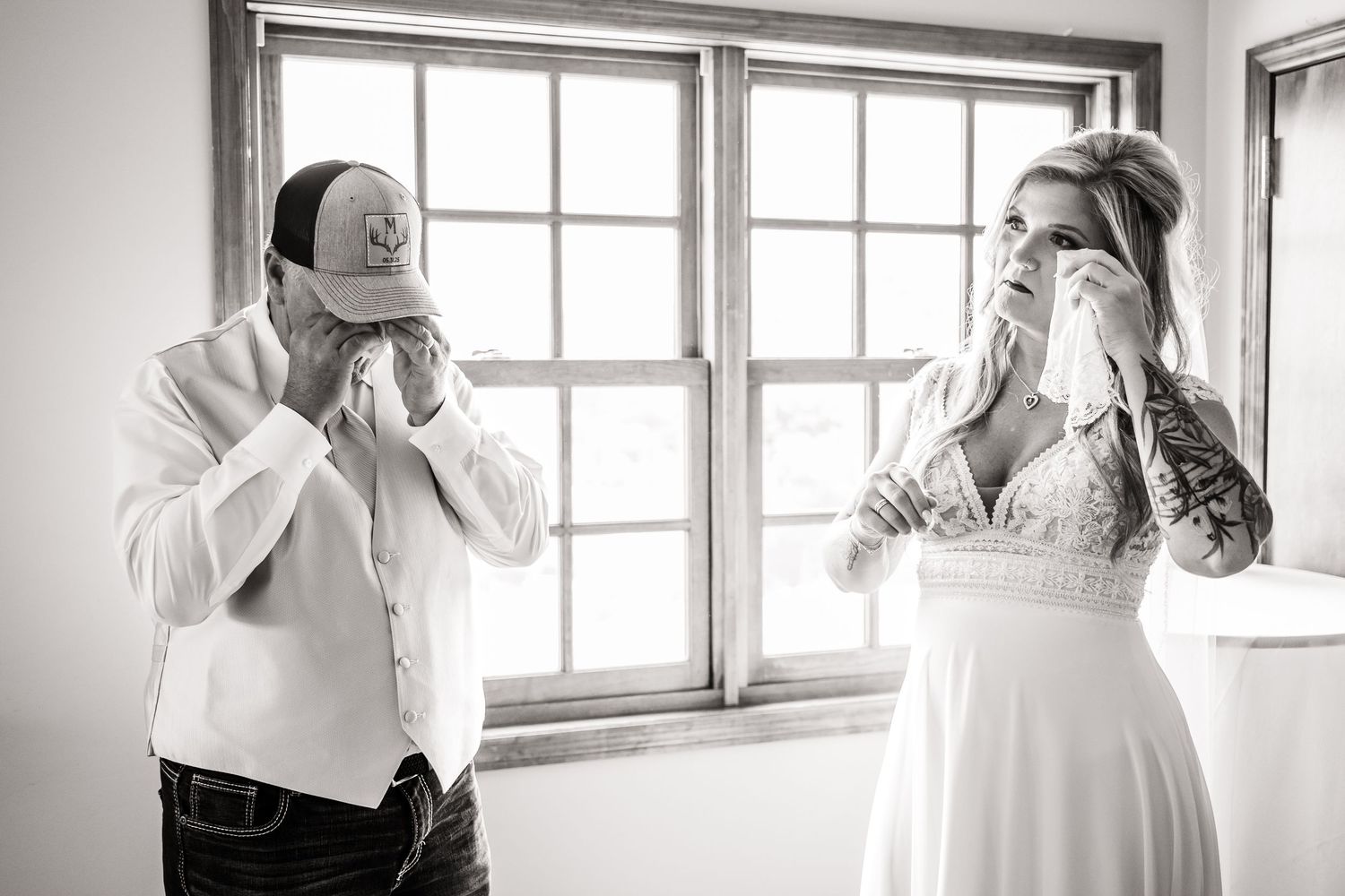 Black and white wedding preparation photos showing intimate moments of getting dressed and final touches before ceremony.