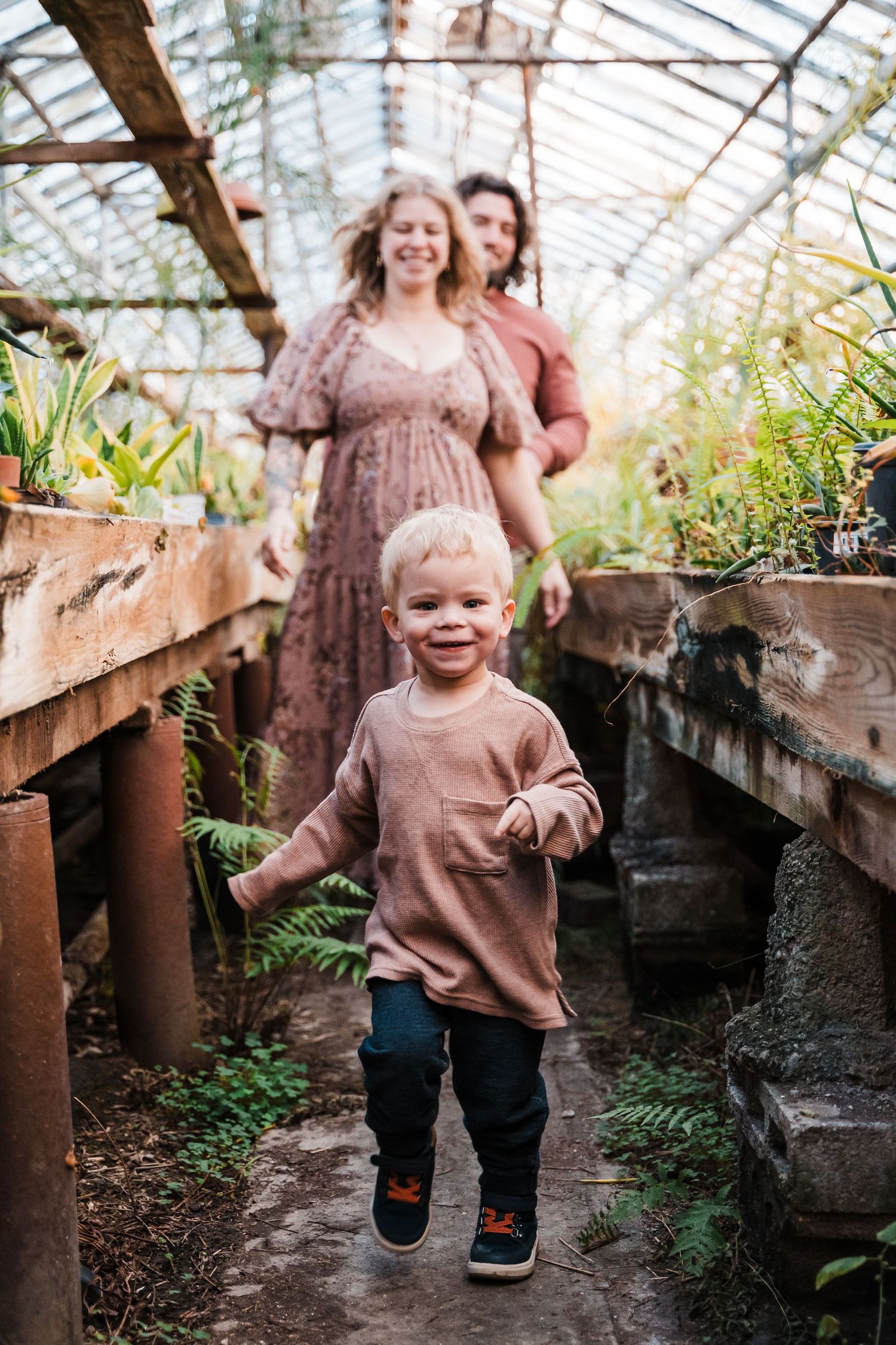 A series of candid moments captured in a greenhouse showing joyful movement and laughter among plants and natural light.