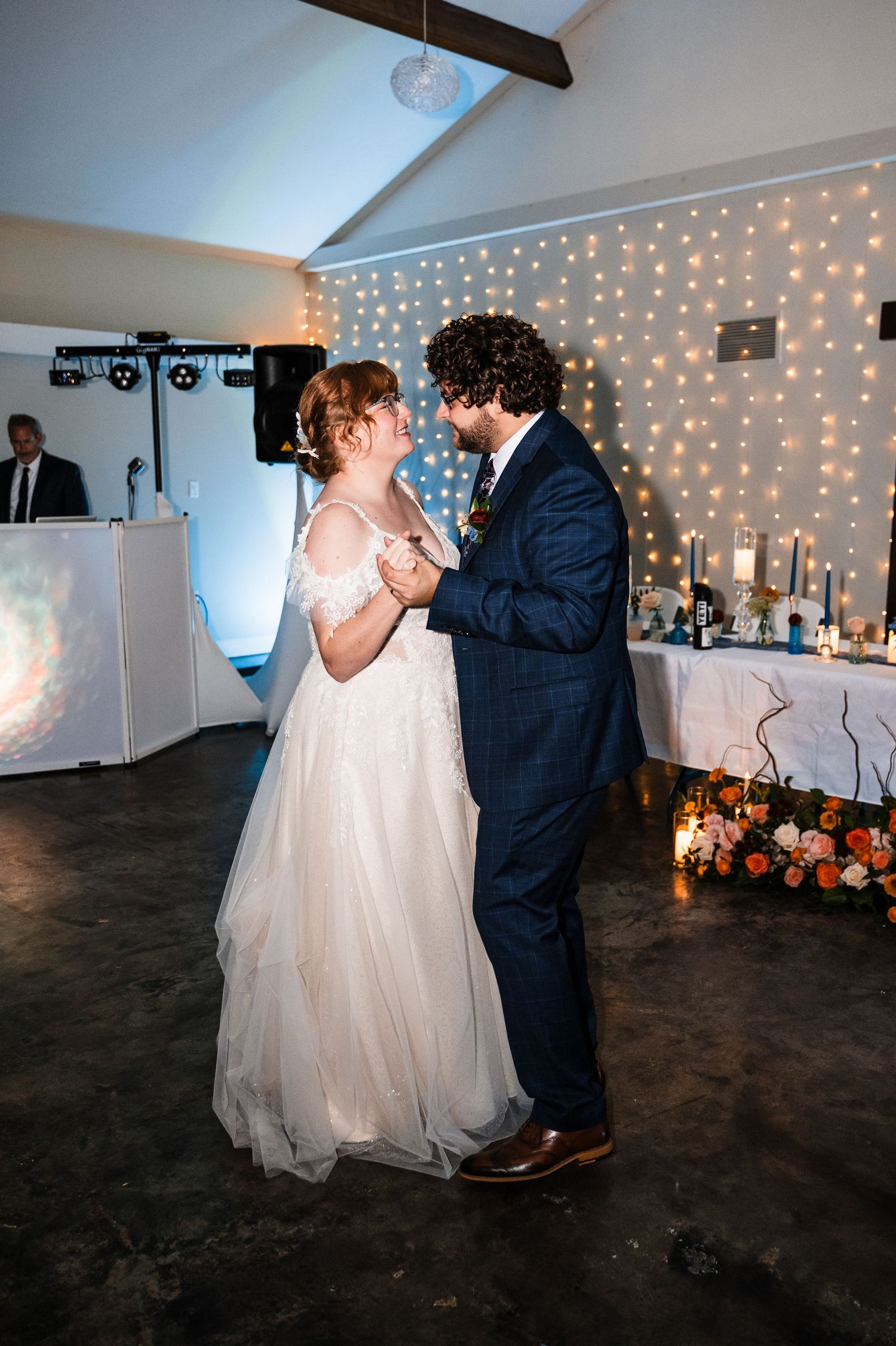 First dance at wedding reception with twinkle lights and romantic atmosphere.