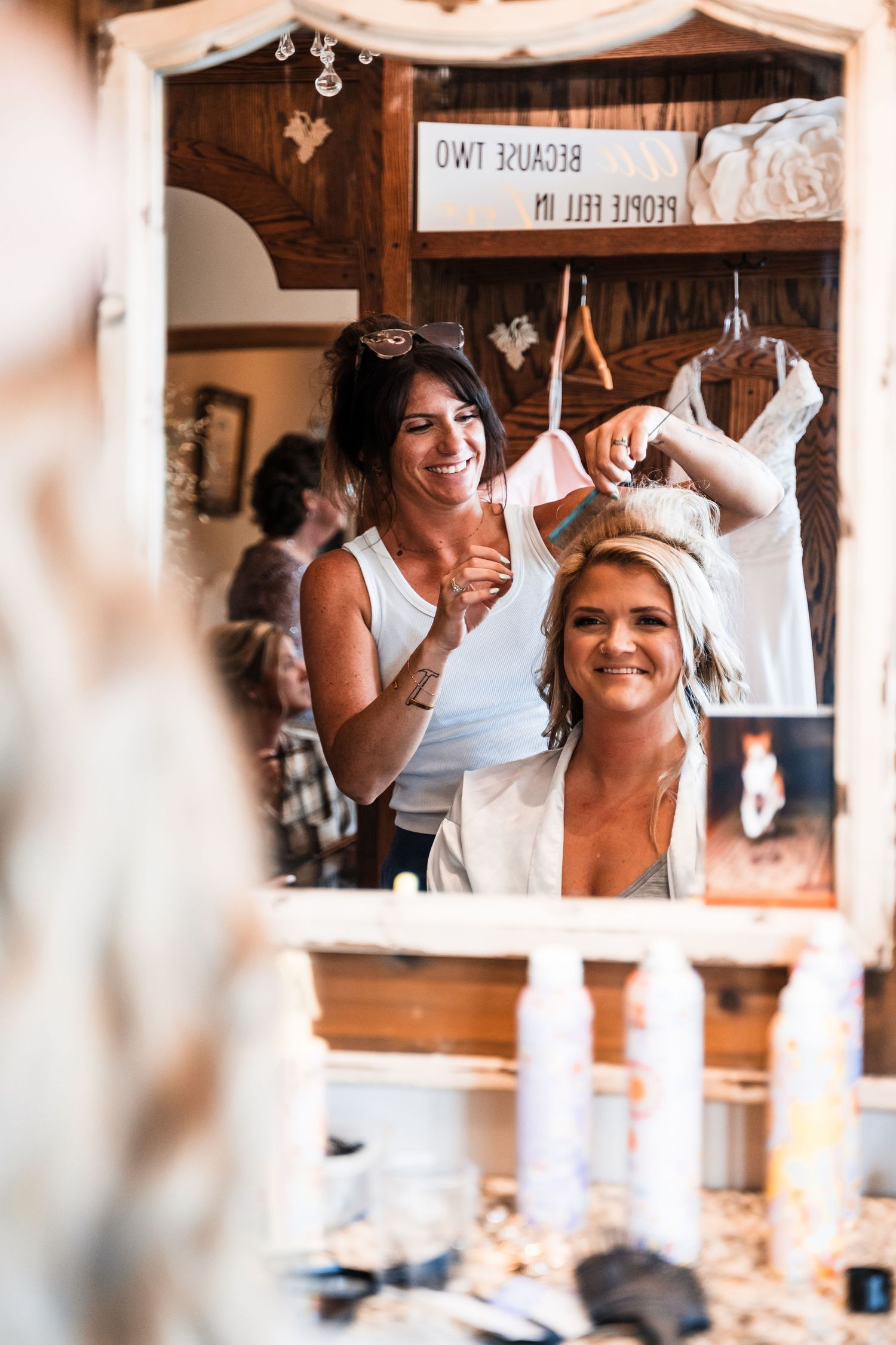 Wedding preparation scene through window frame with joyful expressions.