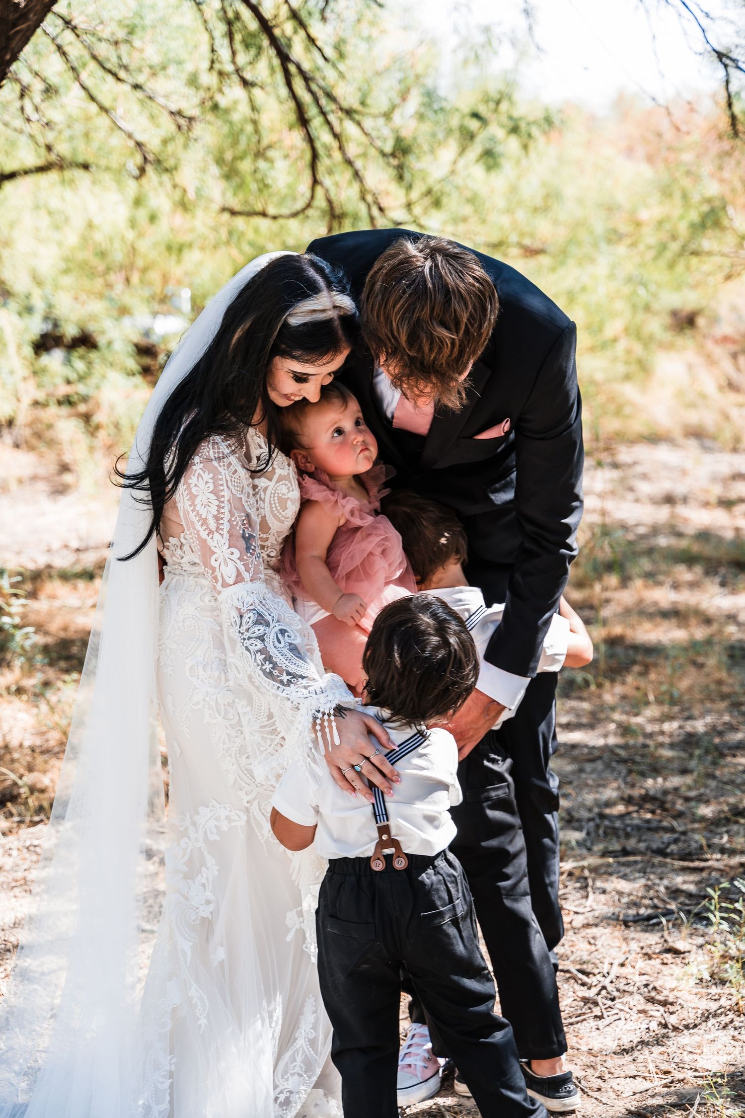 Intimate family moment captured during a desert wedding photoshoot.
