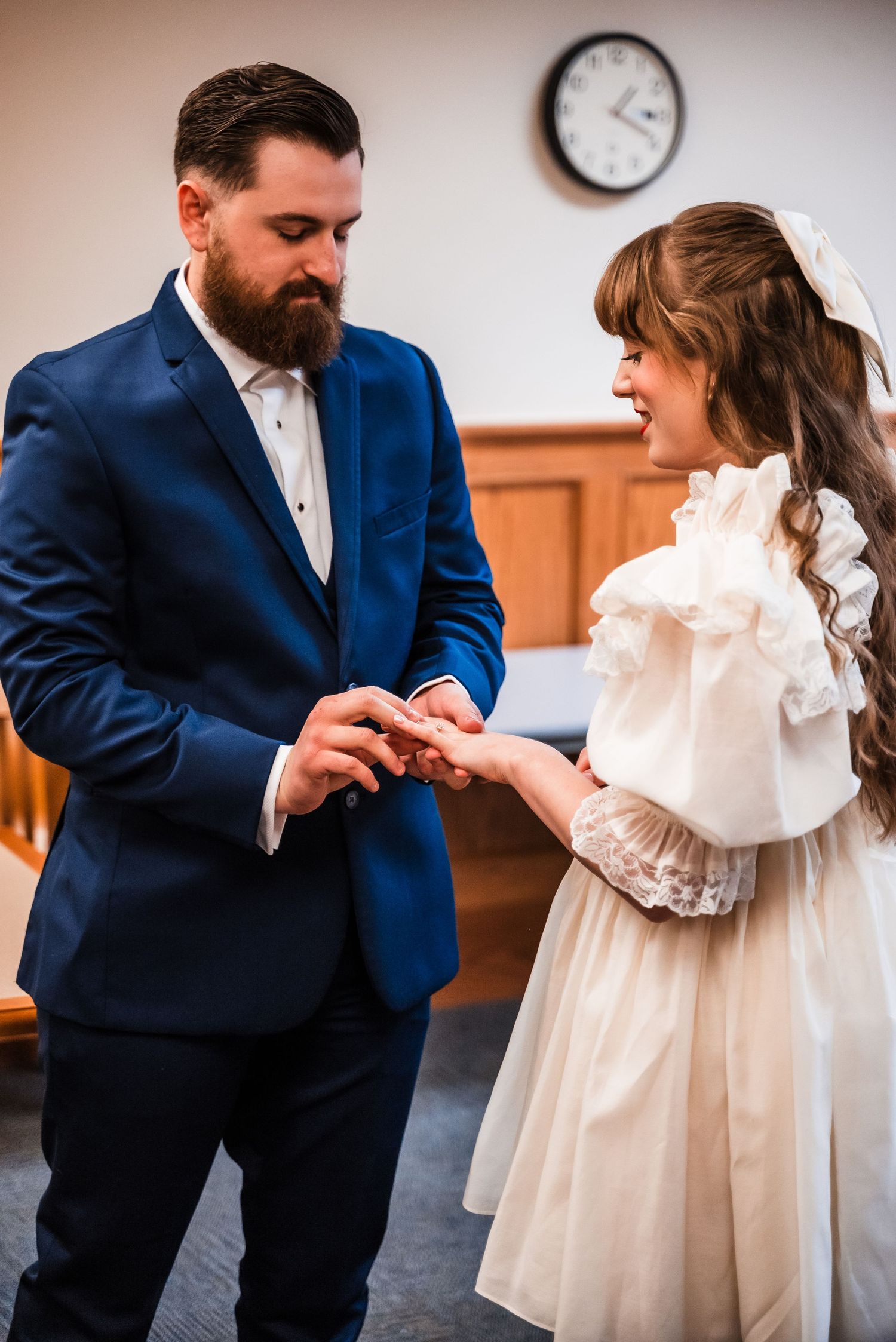 A couple exchanges rings during an intimate courthouse wedding ceremony.