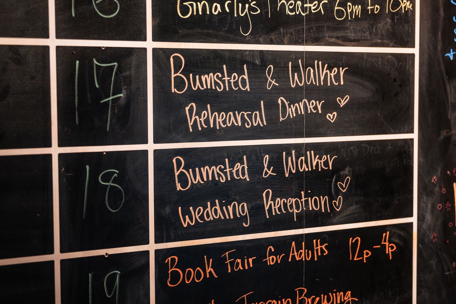 Chalkboard event schedule showing Bumsted & Walker Rehearsal Dinner and Wedding Reception listings on dates 17 and 18.