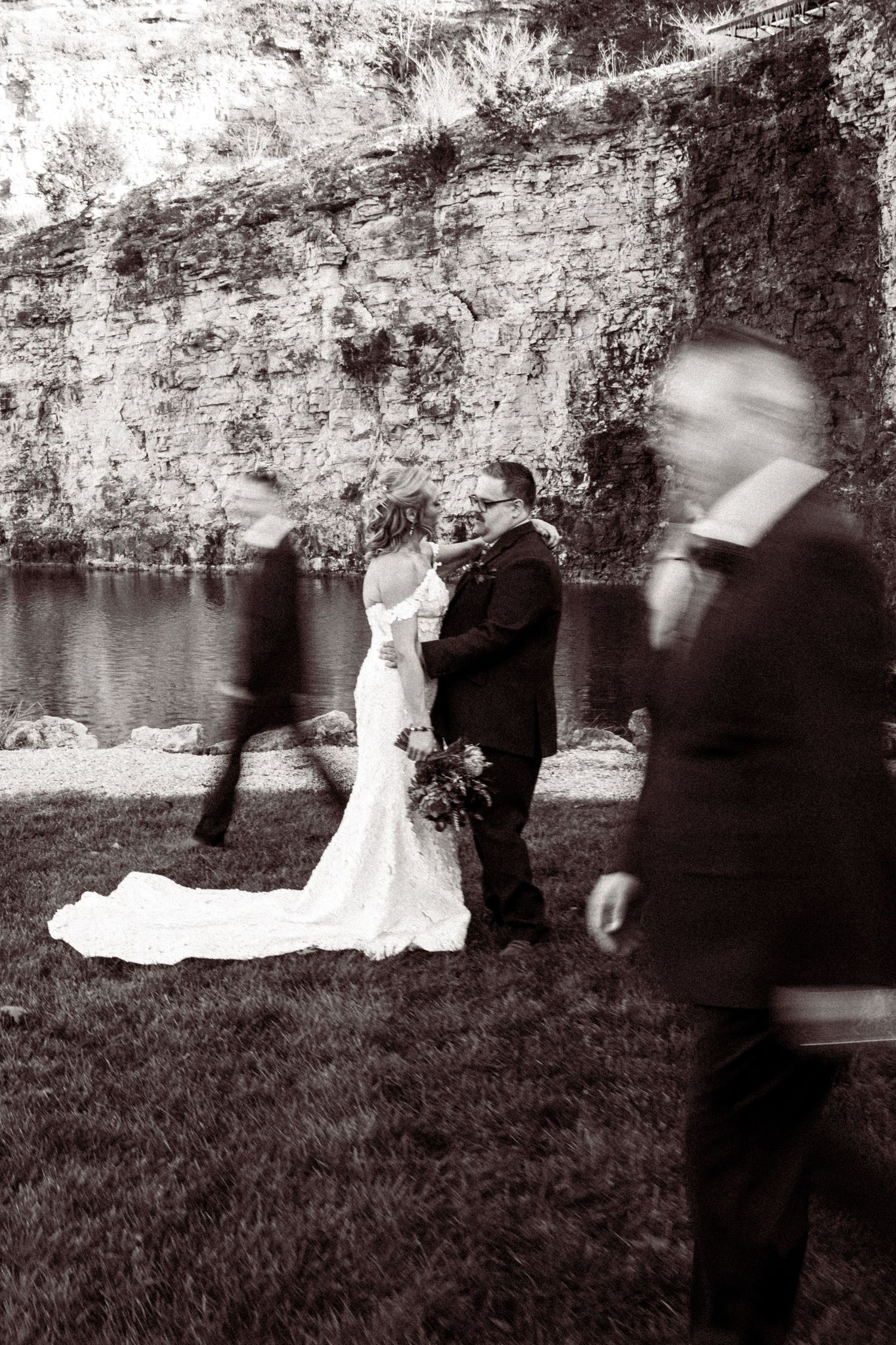 Black and white artistic sequence showing blurred movement of a couple dancing on grass.