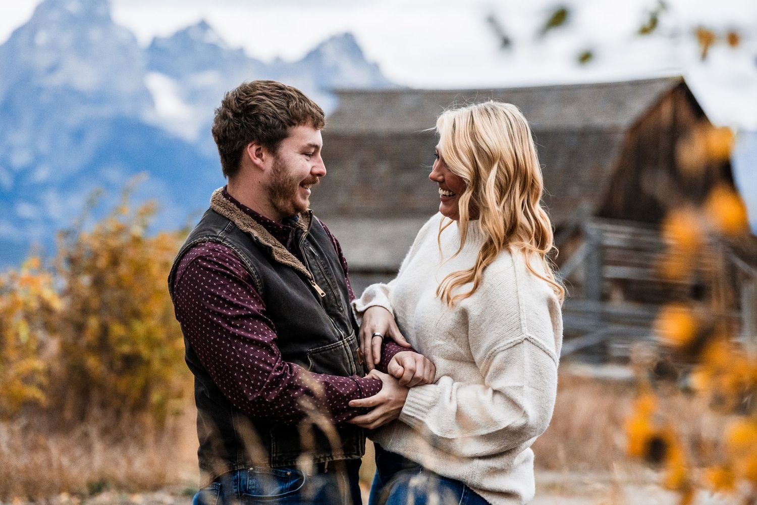 Romantic outdoor engagement session with mountains and autumn colors in the background.