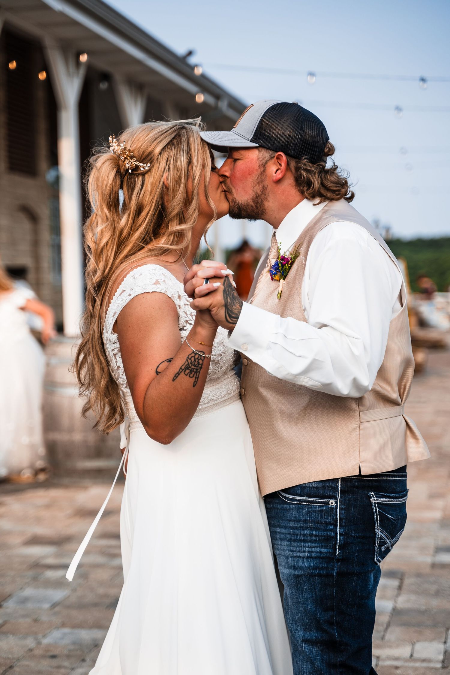 Wedding couple shares playful first dance sequence on outdoor patio.