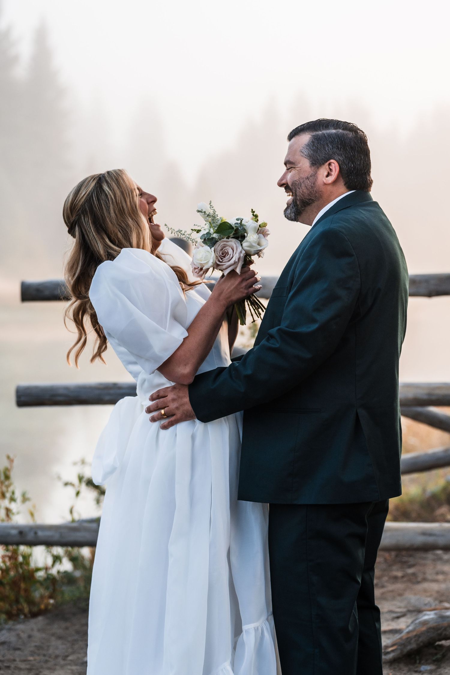A couple shares an intimate moment during their wedding photoshoot against a soft, dreamy background.