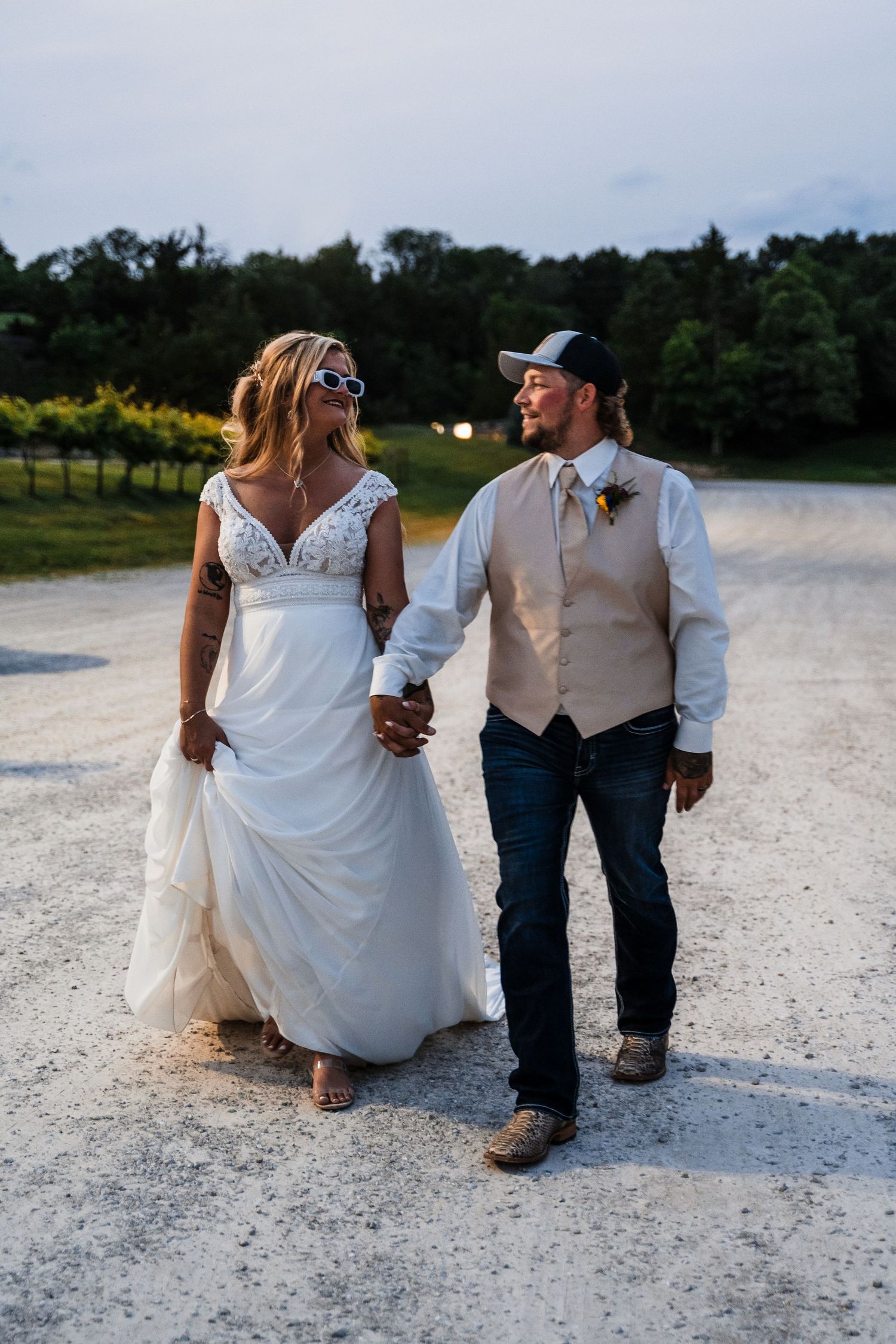 Candid wedding photos on a sandy beach showing close-up details of the couple's outfits and casual style.