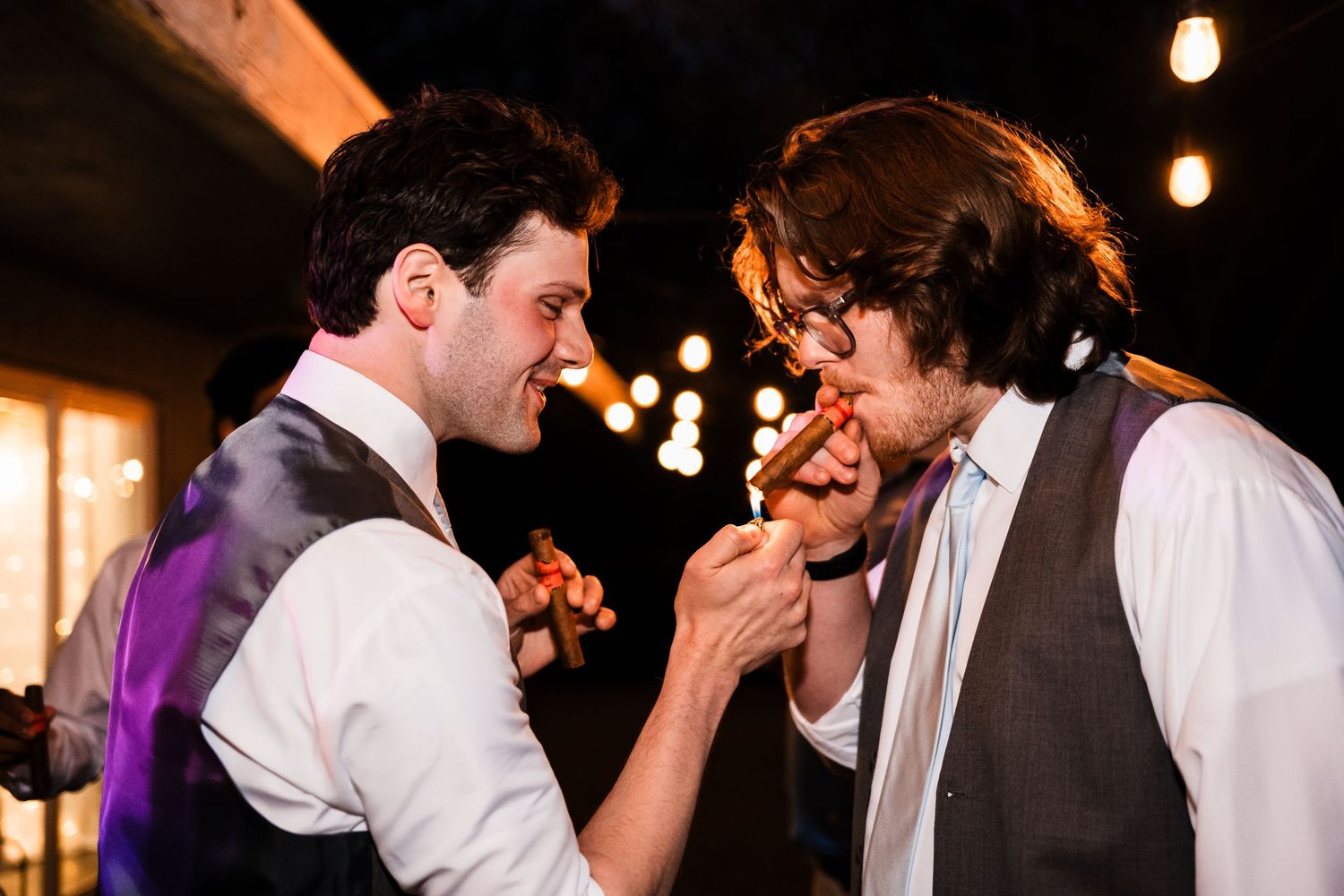 Two people in formal attire sharing a fun moment during a wedding celebration.