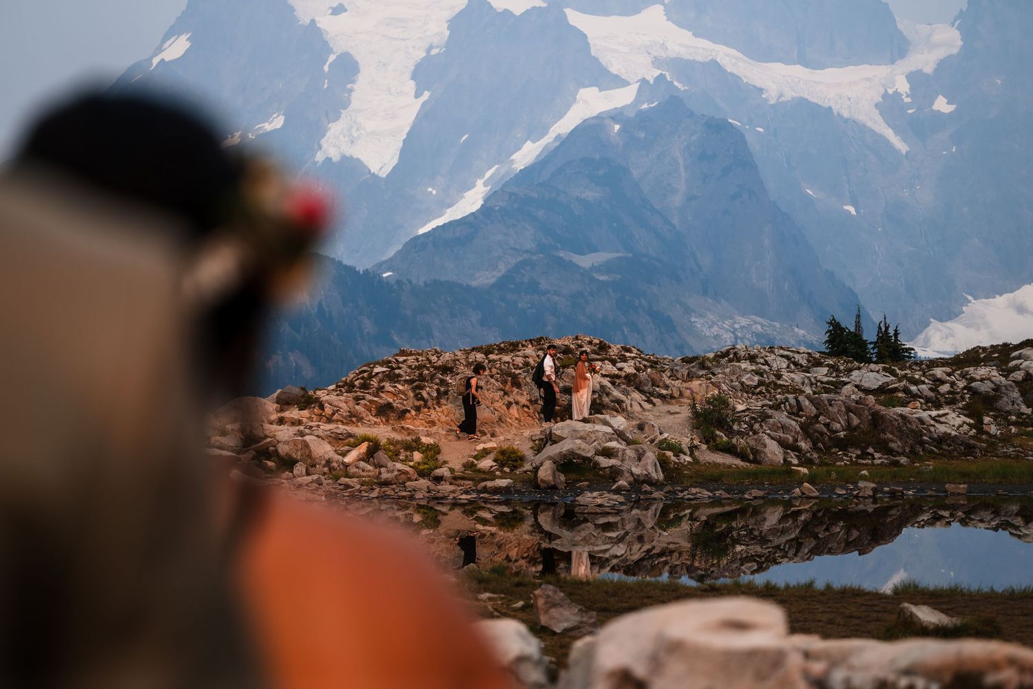 A scenic mountain landscape with jagged peaks and alpine lake reflecting the rugged terrain.