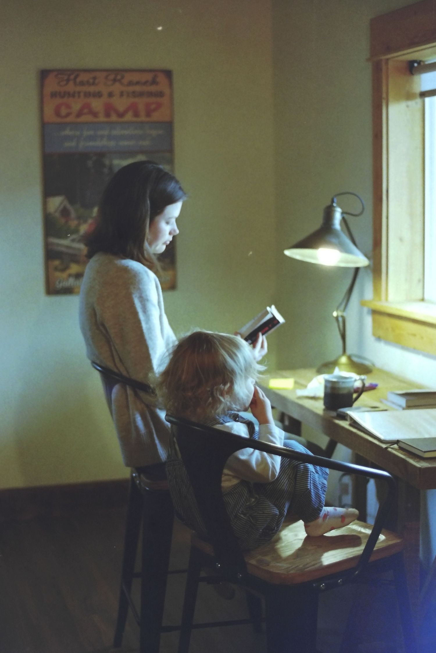 A sequence of five photos showing someone studying at a desk near a window in a dimly lit room.