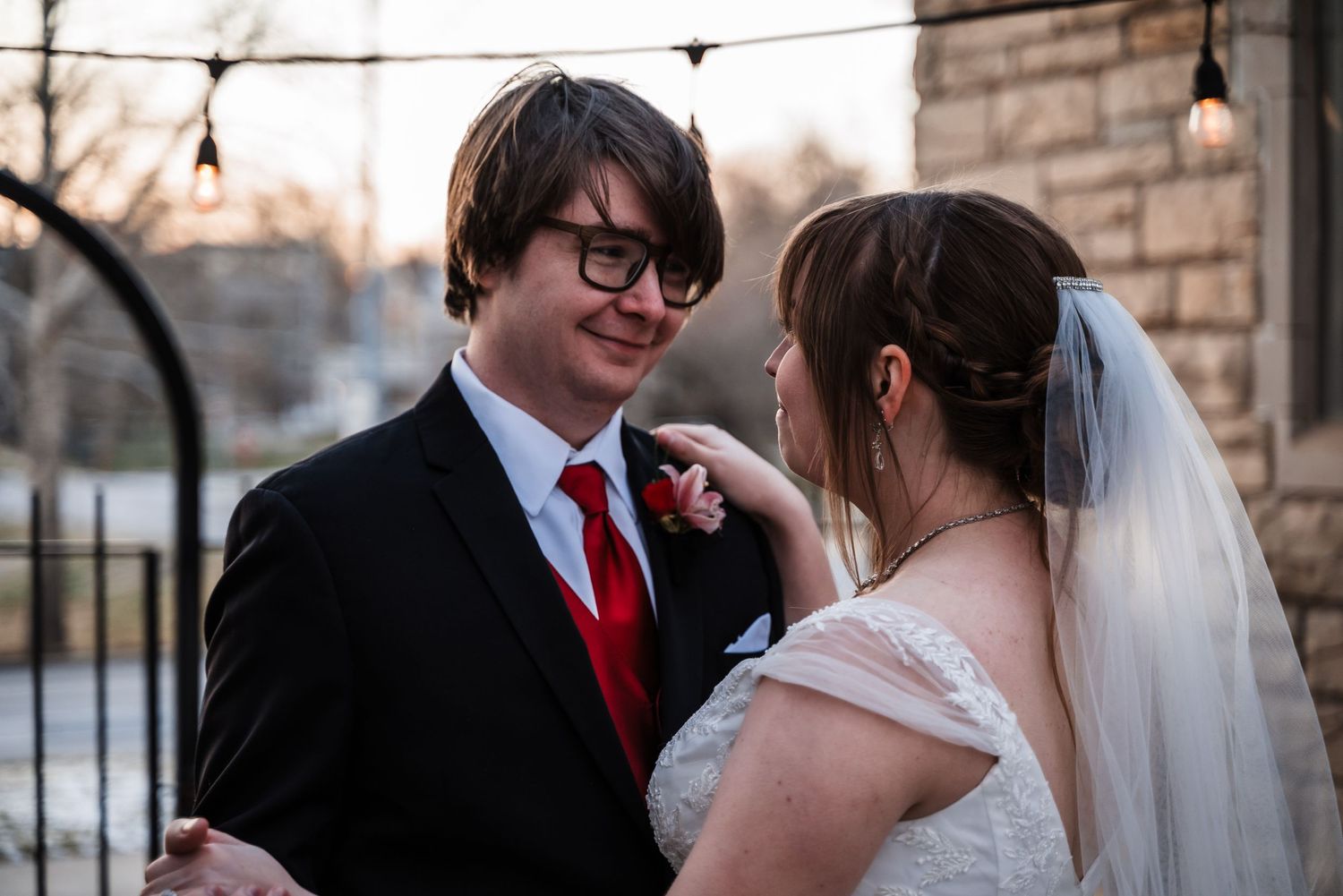 A tender moment between newlyweds as they share an intimate conversation at their winter wedding.