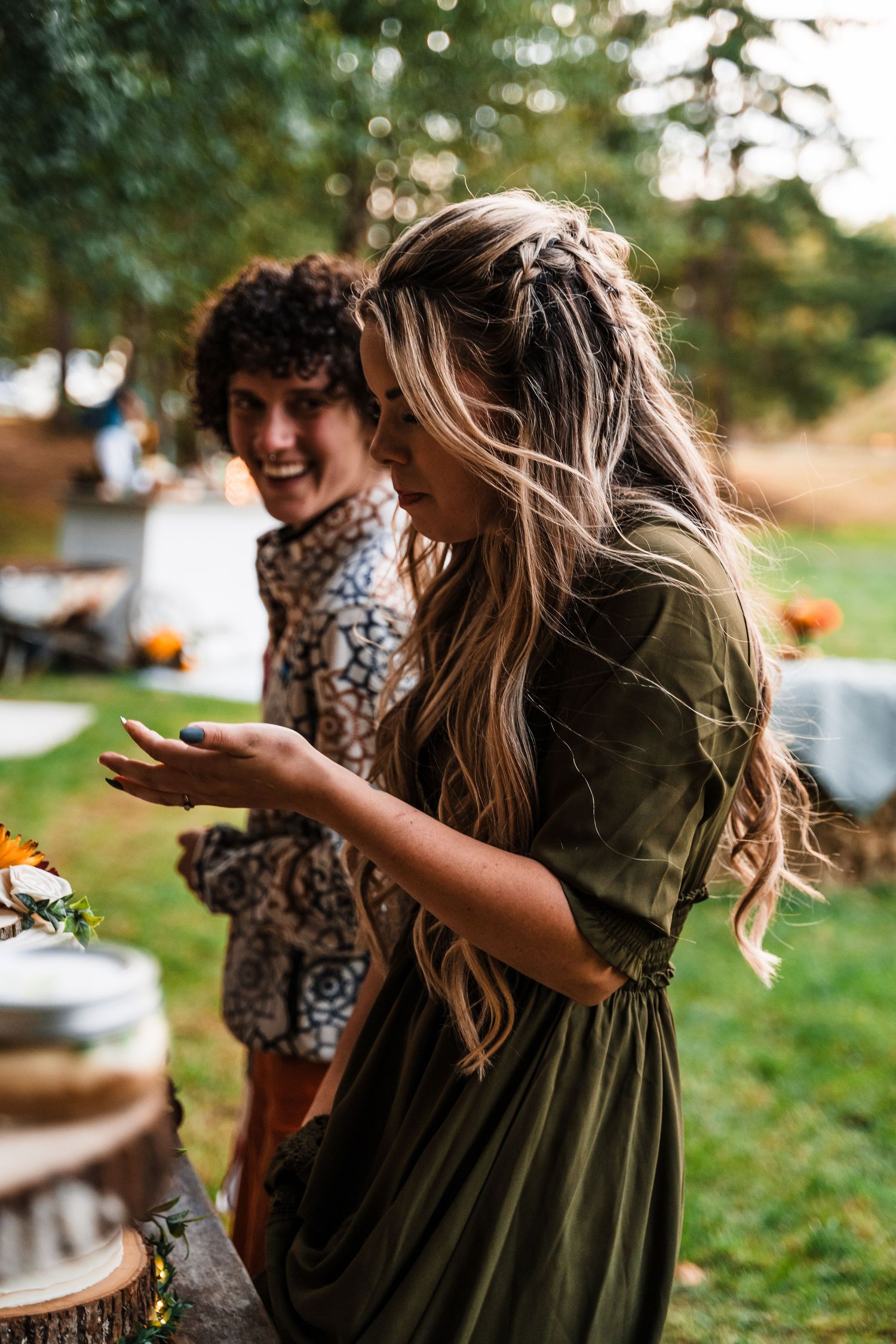 Candid moment of joyful conversation at an outdoor gathering.