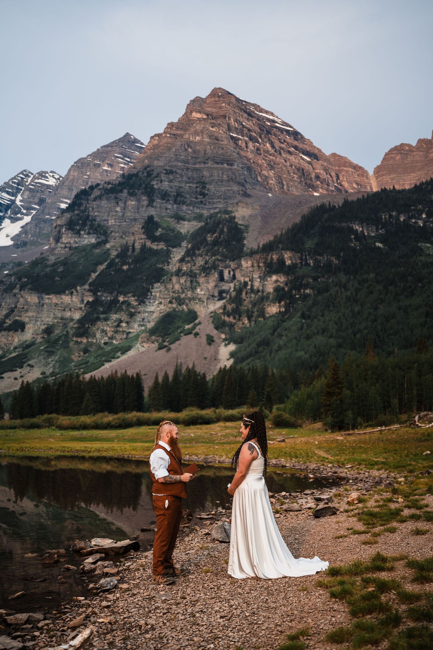 Couple exchanges vows at Maroon Bells Colorado with stunning mountain backdrop.