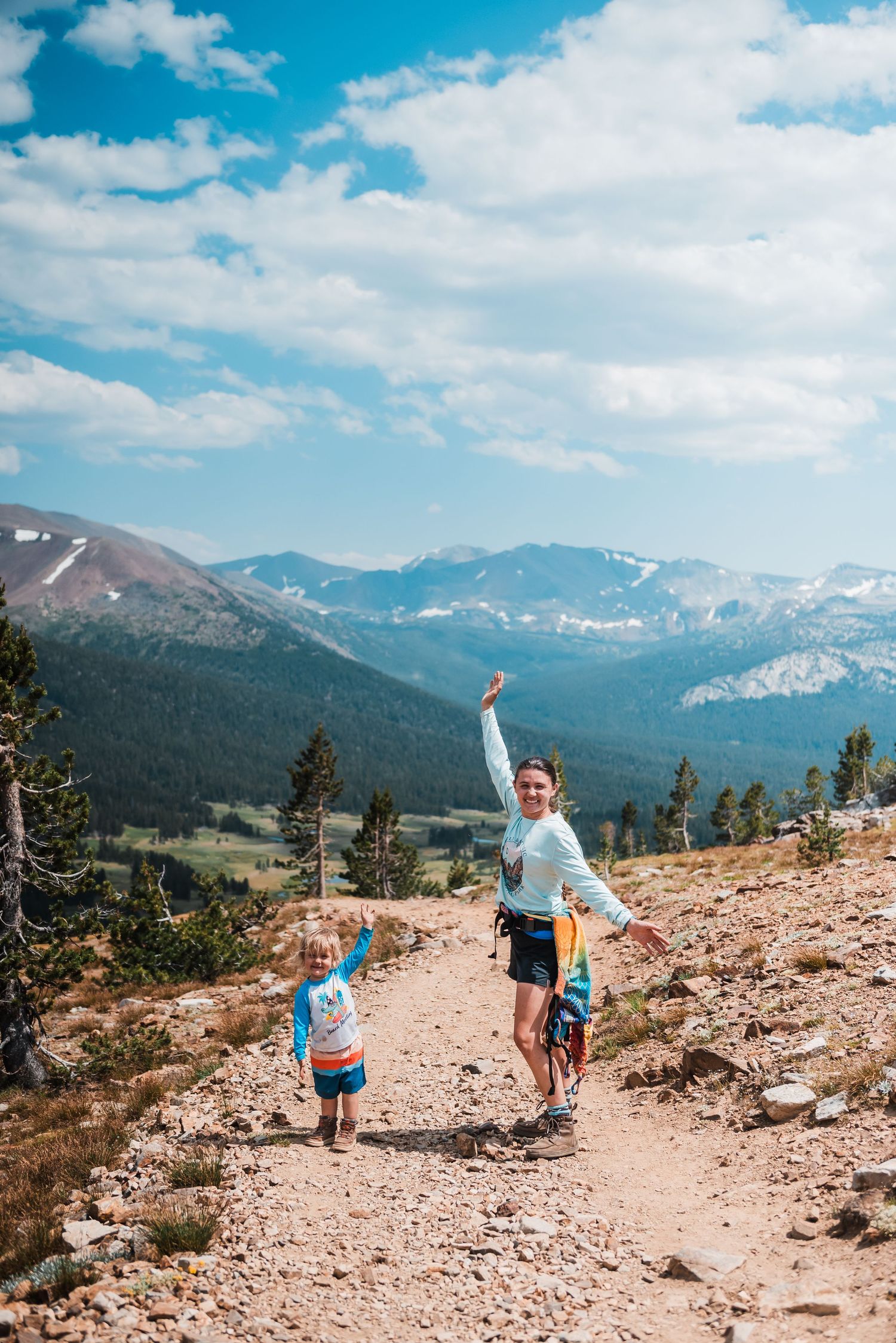 Hiking along a mountain trail with stunning views of the Rocky Mountain range.