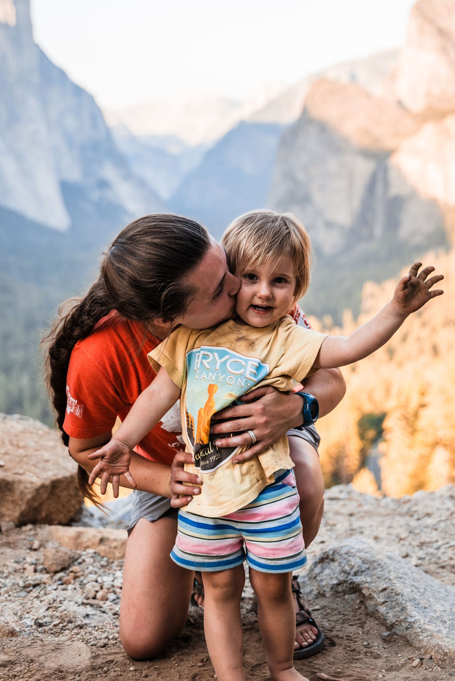 Joyful moment captured against the majestic backdrop of Yosemite's granite cliffs at sunset.