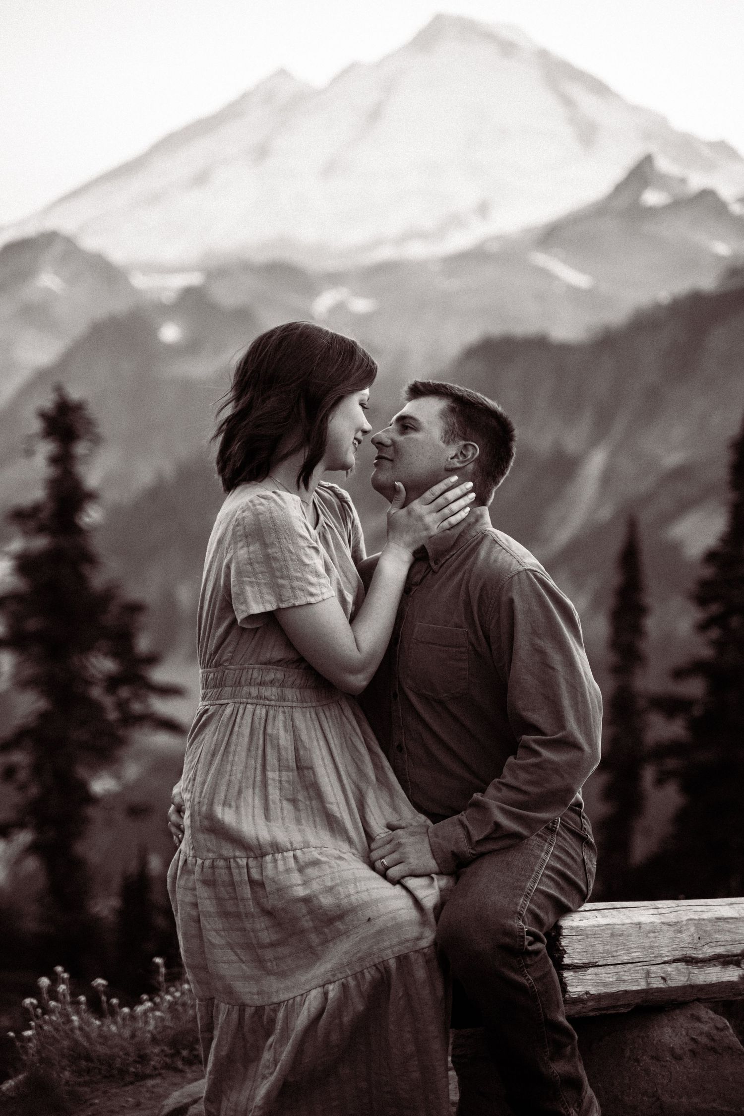 A romantic black and white photo sequence showing a couple sharing intimate moments against a mountain backdrop.