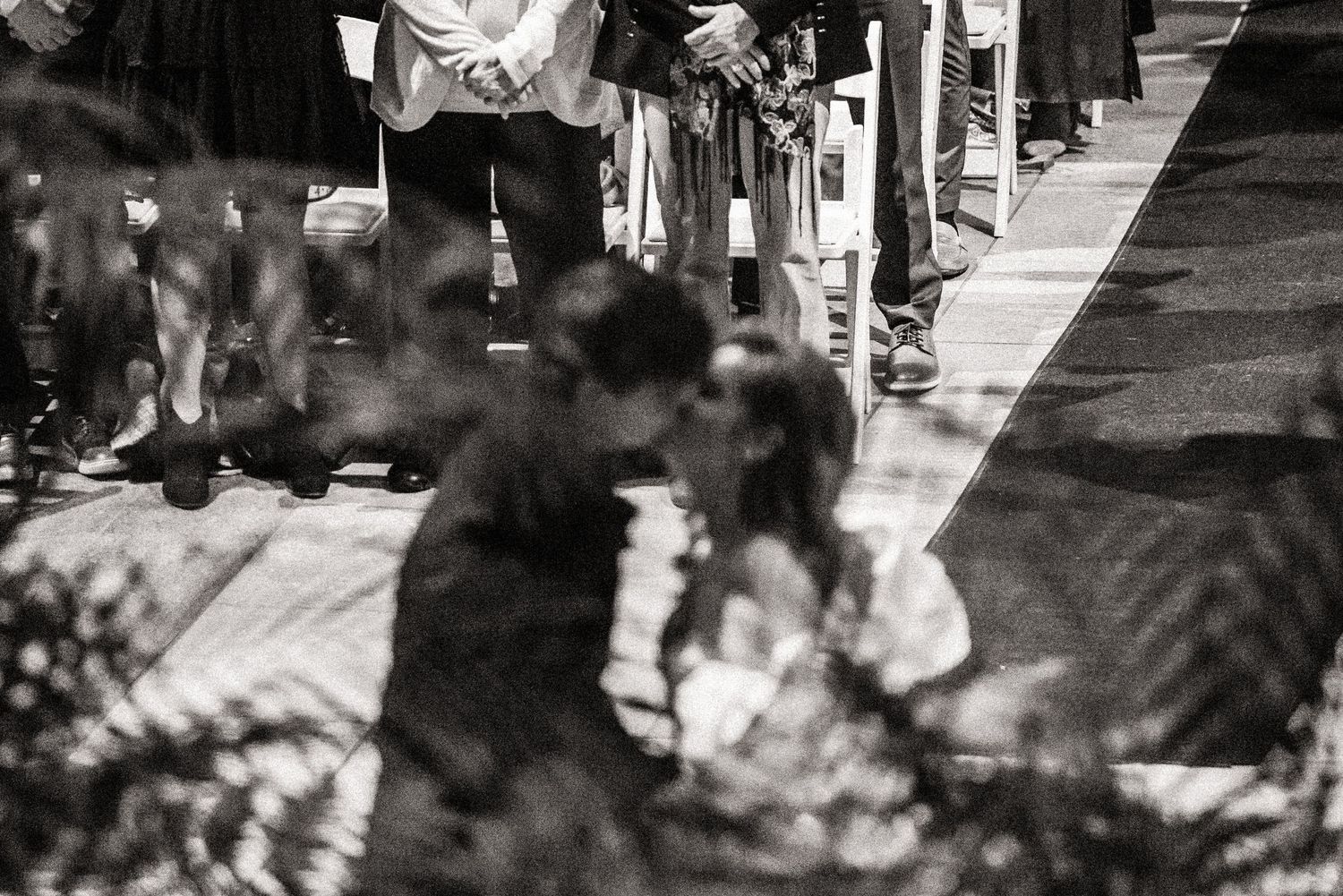 Black and white artistic shot of wedding ceremony shadows cast on the ground.