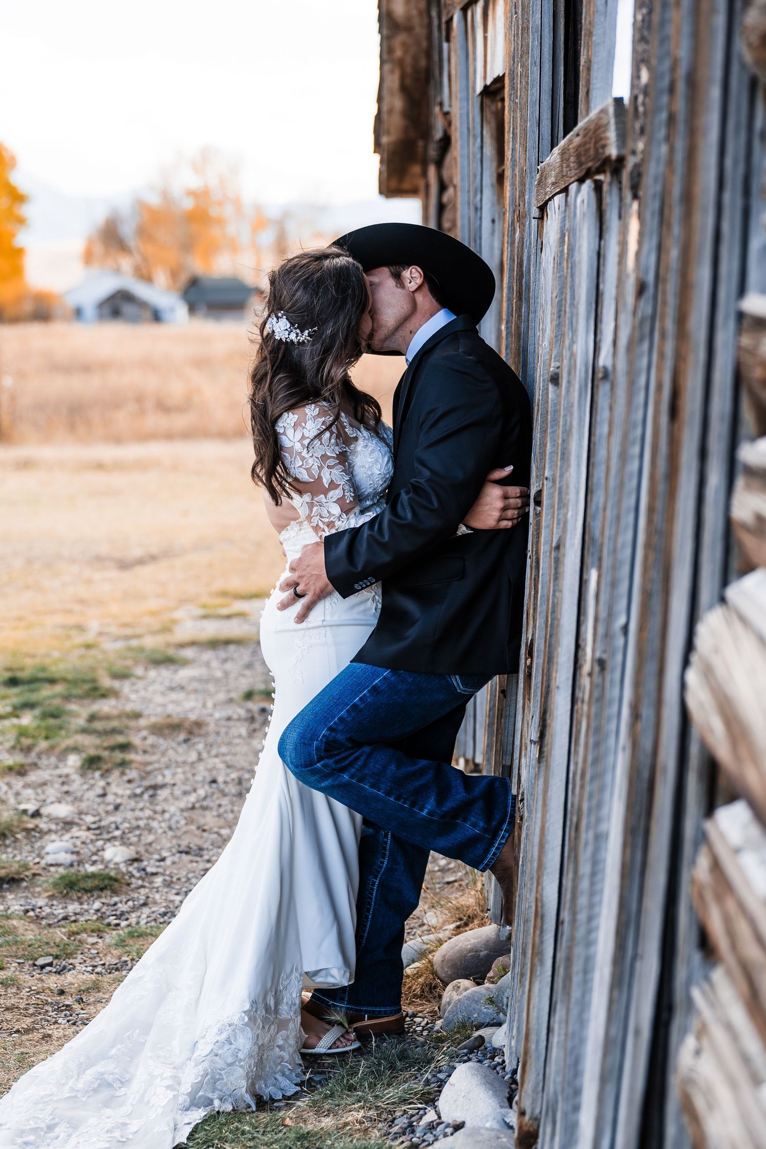 A romantic wedding photo series showing intimate moments against a rustic barn wall at sunset.
