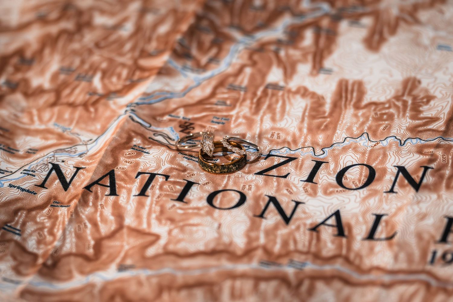 Close-up of a topographic map highlighting Zion National Park with warm brown tones and detailed terrain features.
