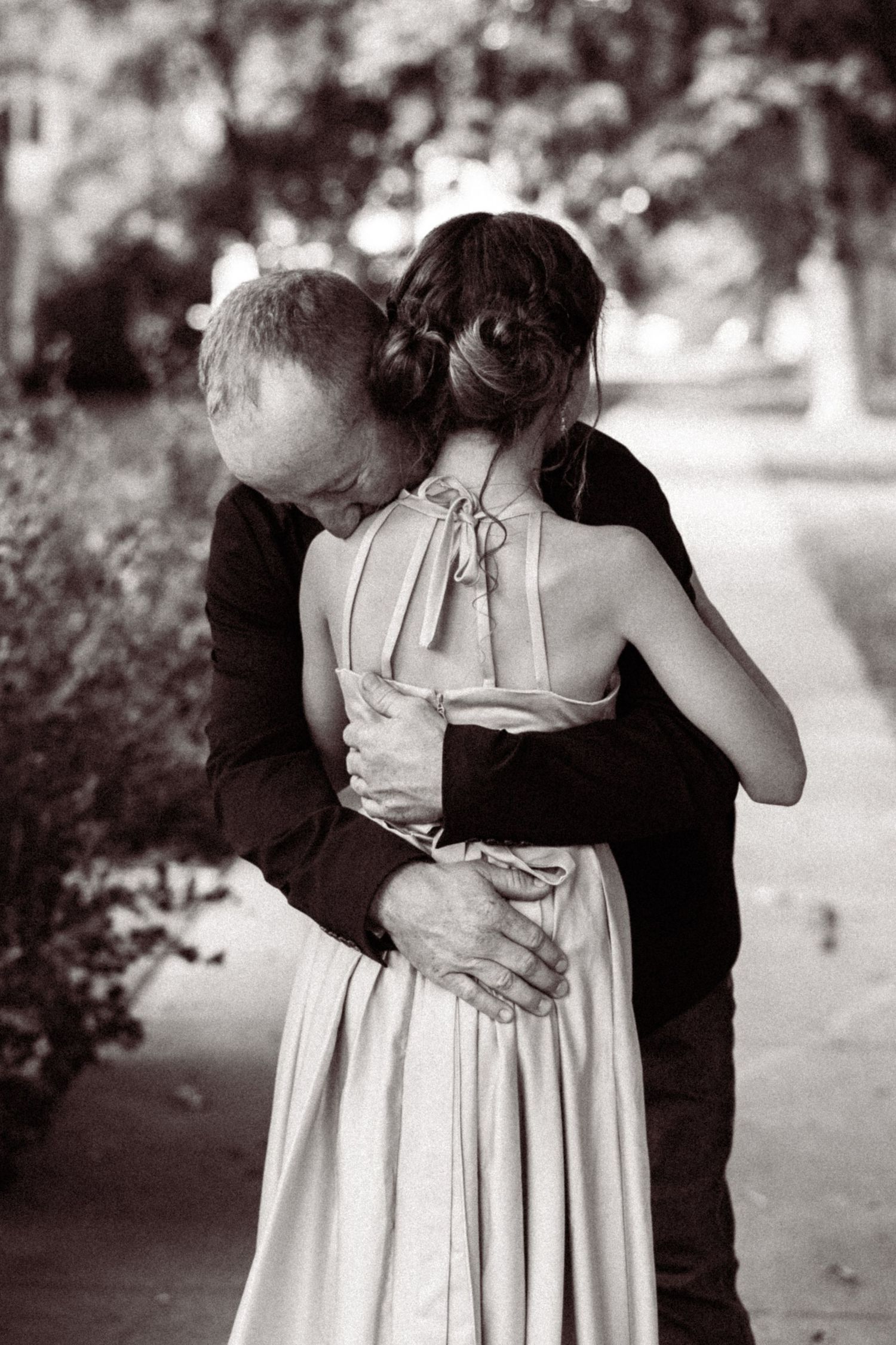 Black and white photos capturing romantic dance poses between a couple in wedding attire.