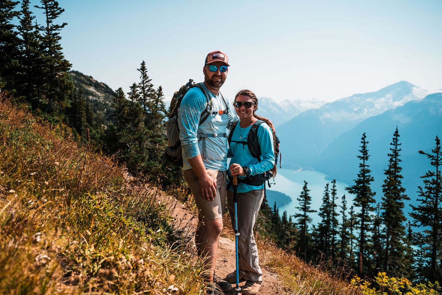 Hikers traverse a scenic mountain trail with stunning alpine views.