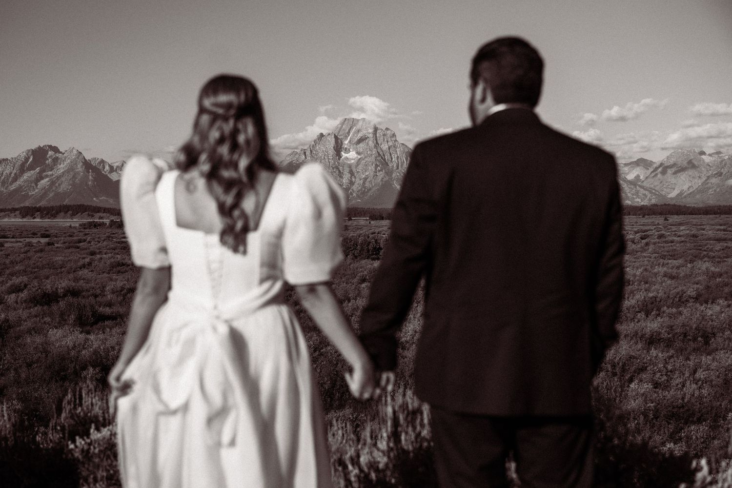 Black and white wedding portraits captured against majestic mountain scenery.
