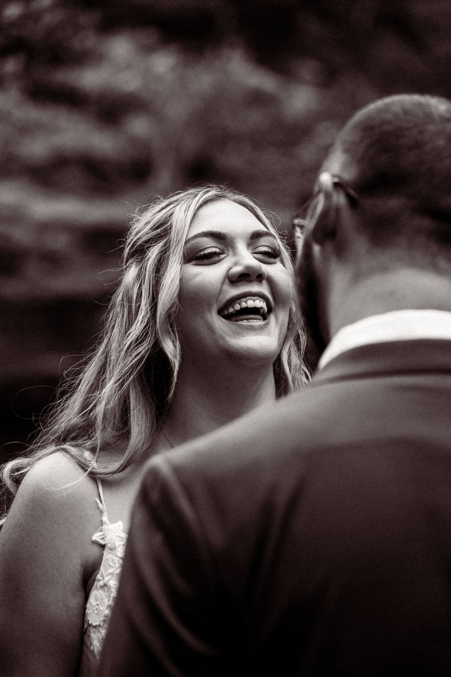 A series of black and white portraits showing joyful laughter and genuine emotion.