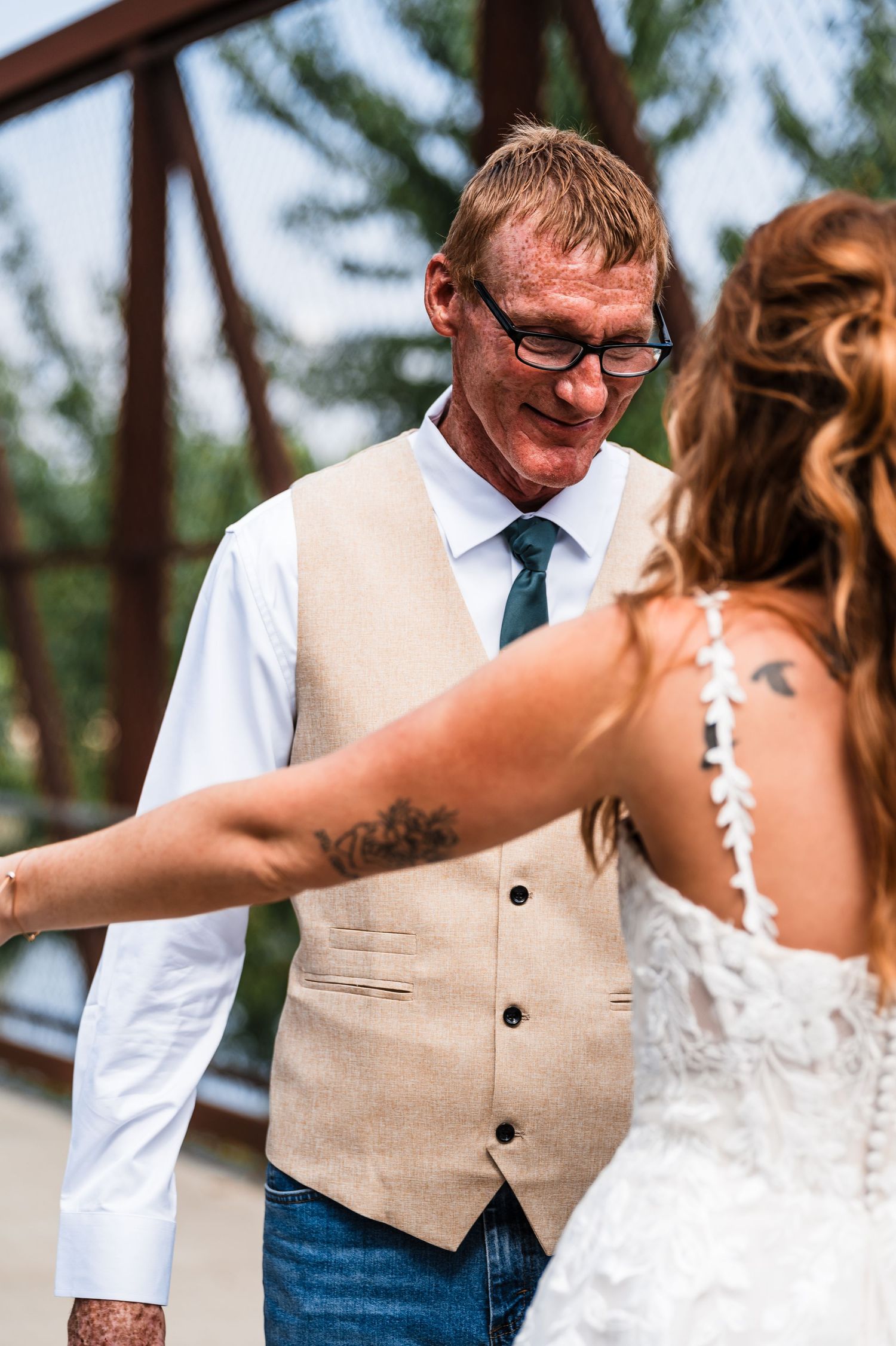 Close-up series of a couple in casual wedding attire sharing an intimate moment against a natural outdoor backdrop.