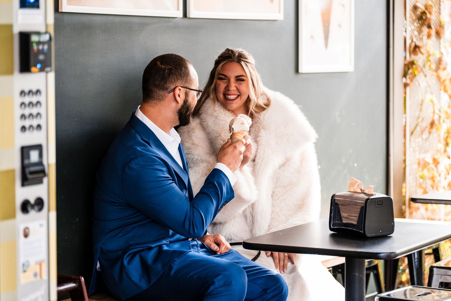 Candid moments of a couple sharing laughs during their wedding day in an indoor setting.