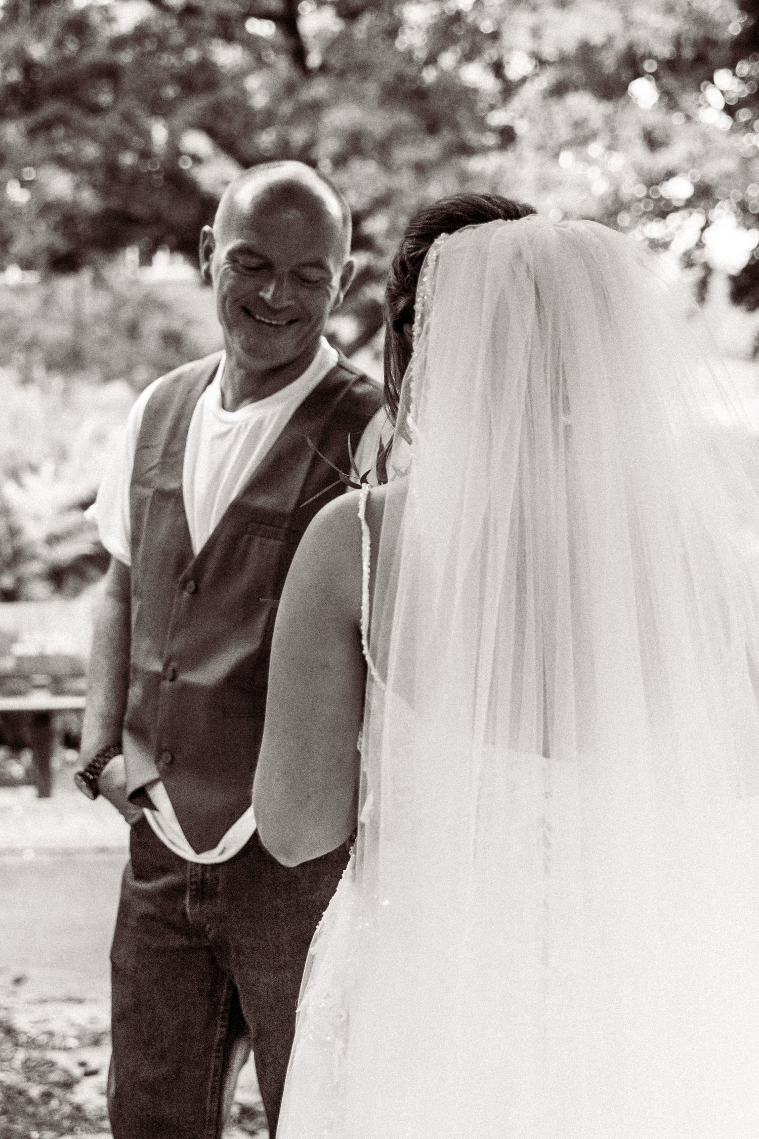 A black and white wedding photo sequence showing playful moments between a couple.