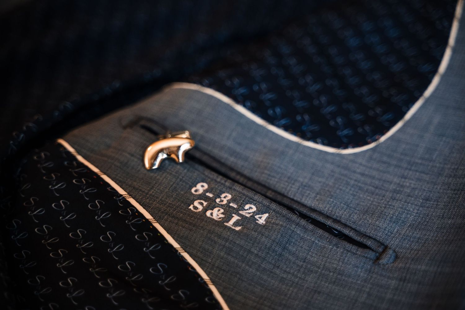 Custom guitar detail showing engraved date and decorative wolf emblem.