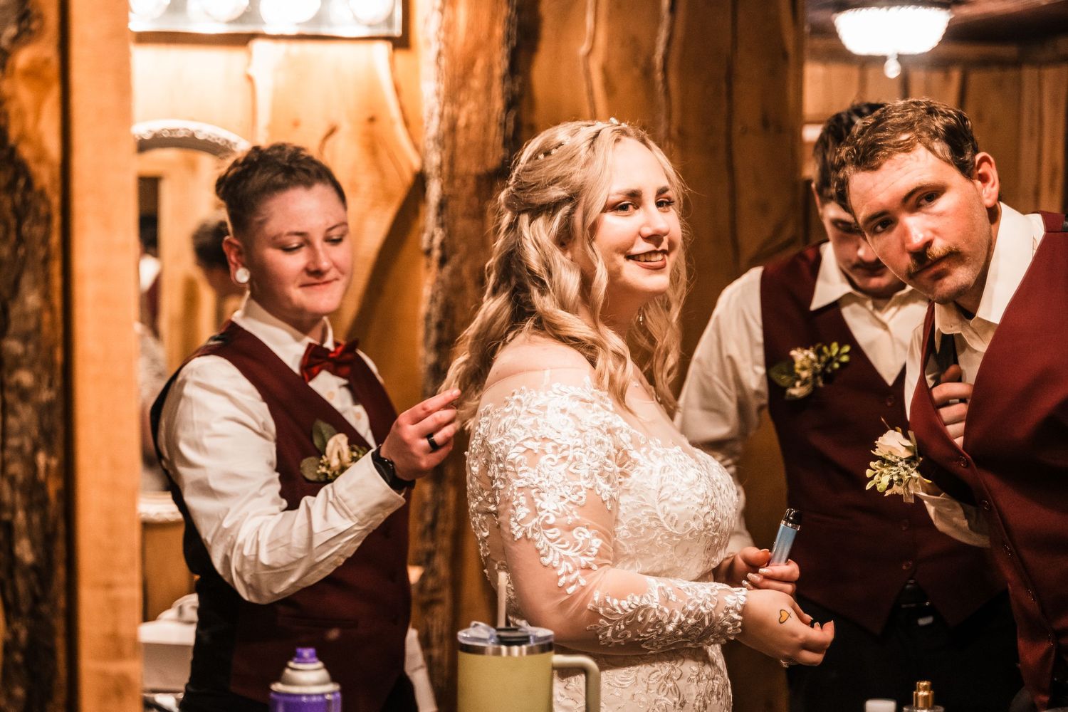 Candid moment of celebration during wedding reception in rustic wooden venue.