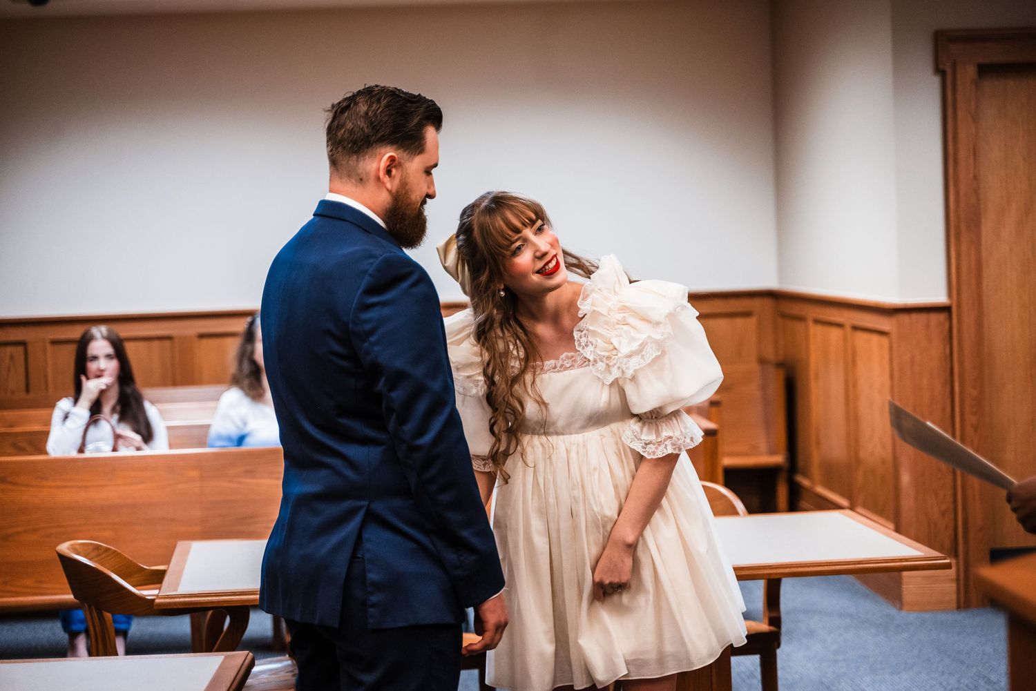 A couple sharing a joyful moment during their courthouse wedding ceremony.