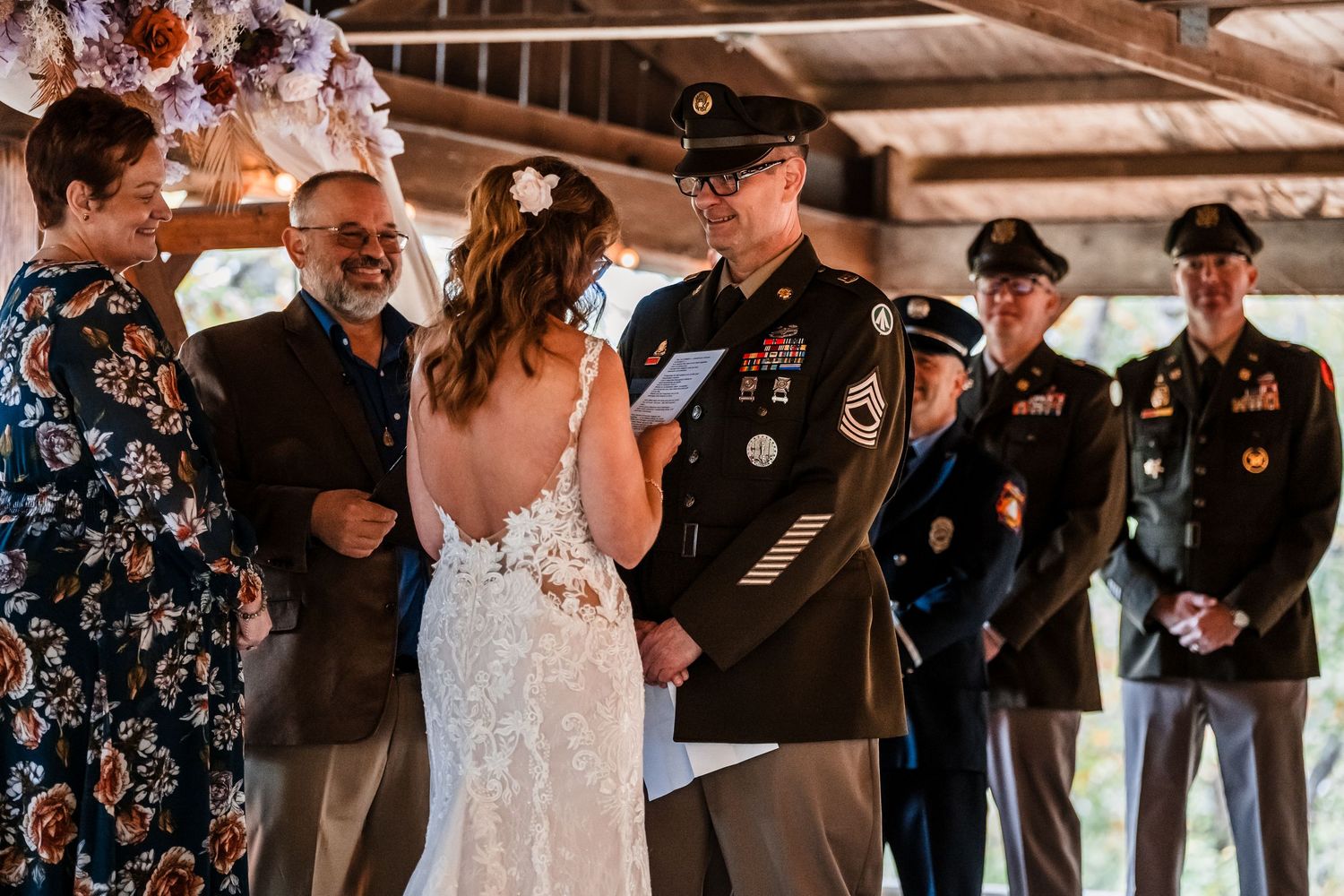 Military wedding ceremony with uniformed servicemen standing at attention.