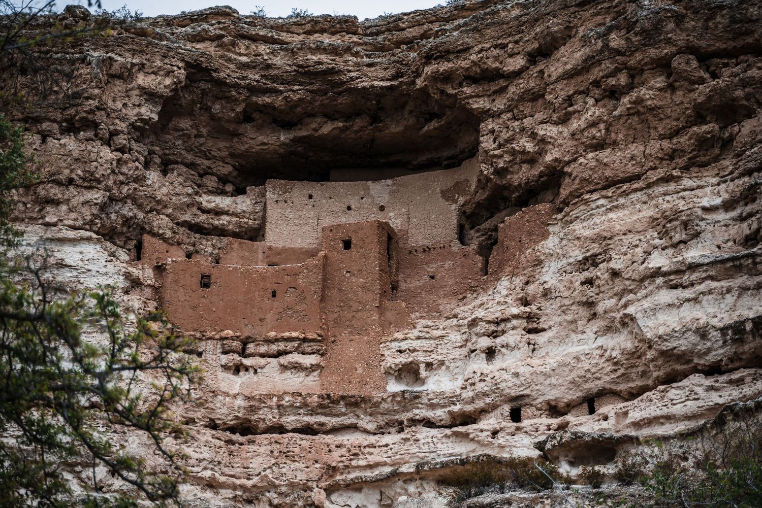Ancient Montezuma Castle cliff dwelling nestled in limestone cave walls at Camp Verde, Arizona.