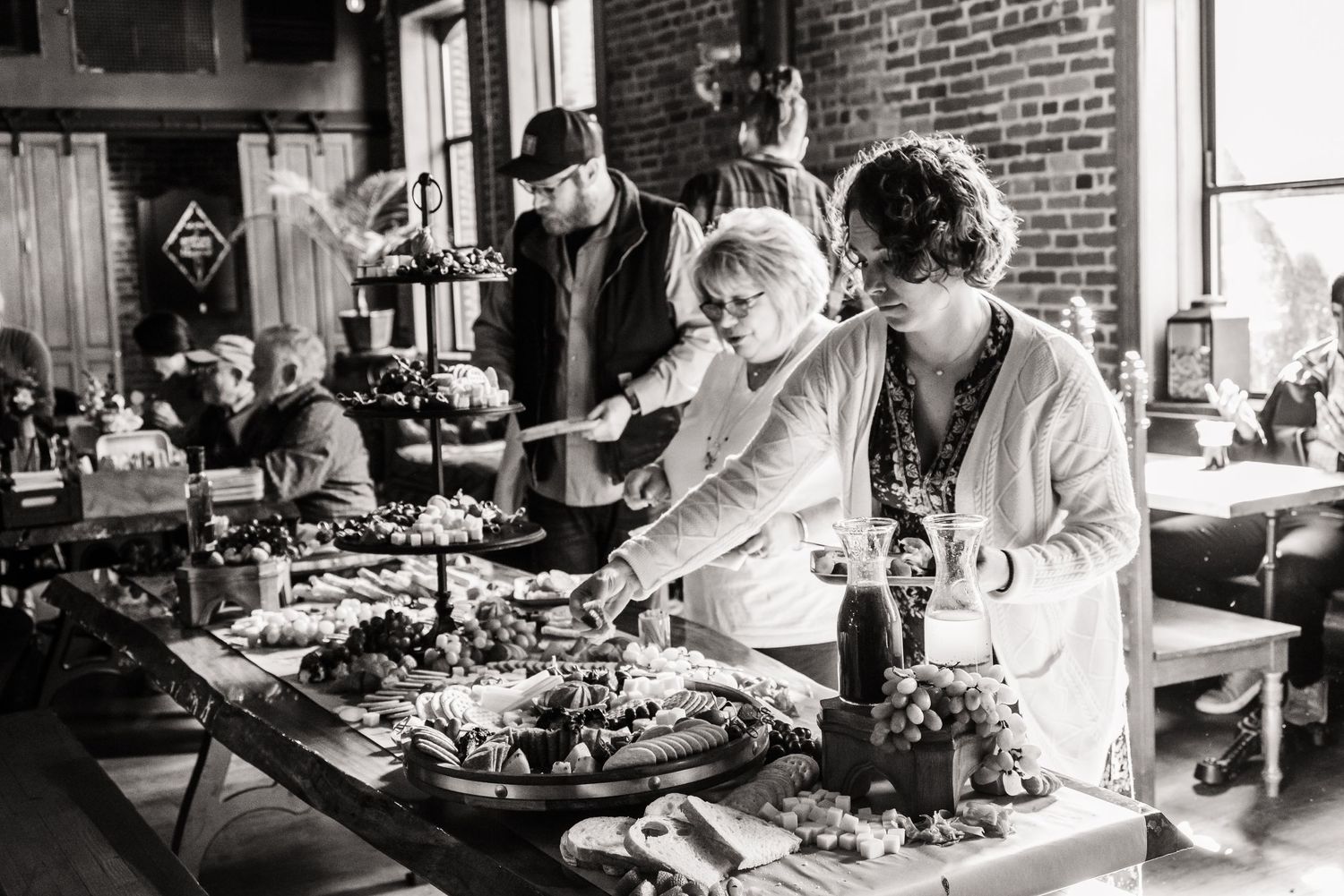 Black and white photo of catering staff preparing food at an event.