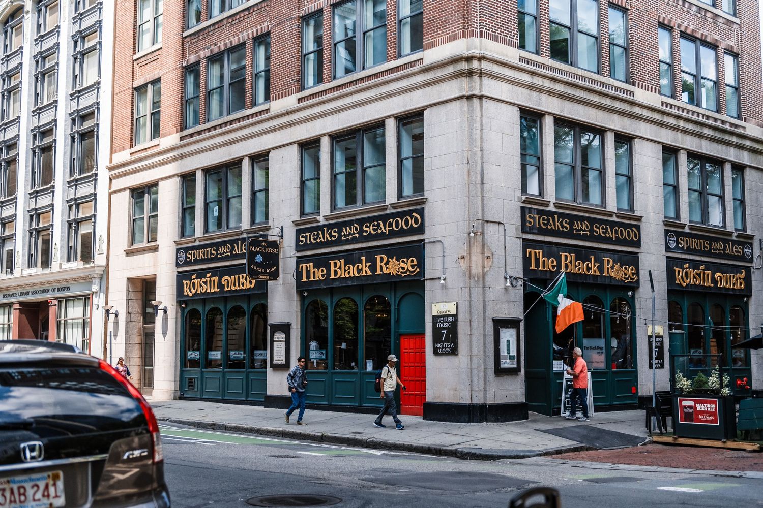 Historic Black Rose Irish pub on a street corner in downtown Boston with classic brick and stone architecture.