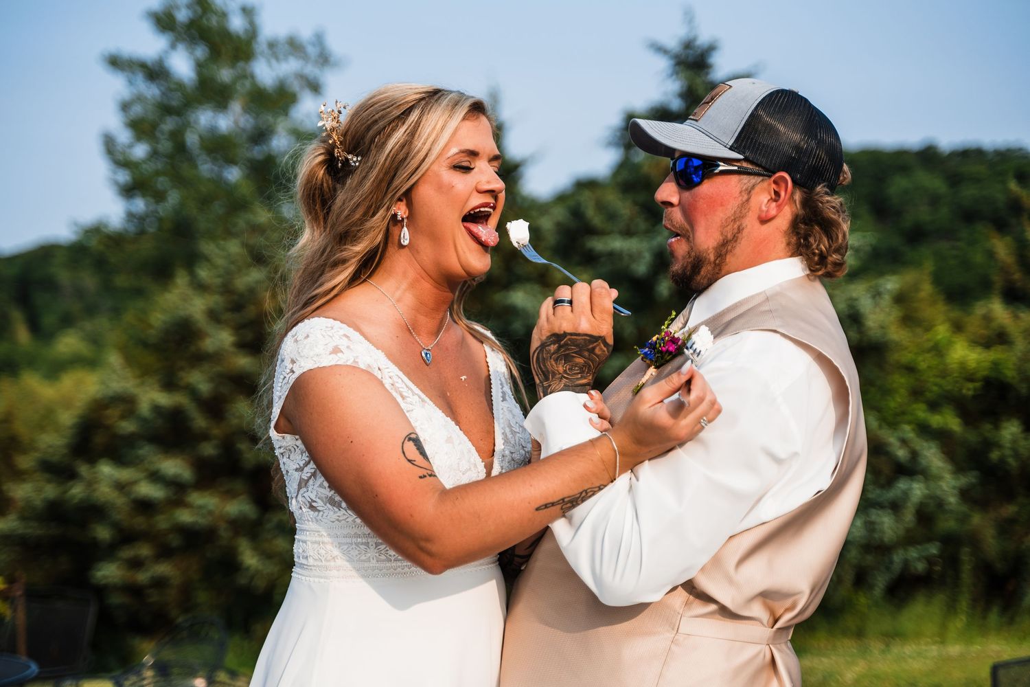 Newlywed couple sharing an emotional first dance together outdoors on their wedding day.