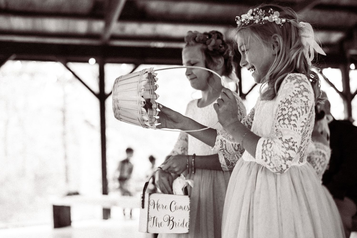 Black and white photo of attendees at an outdoor wedding celebration.